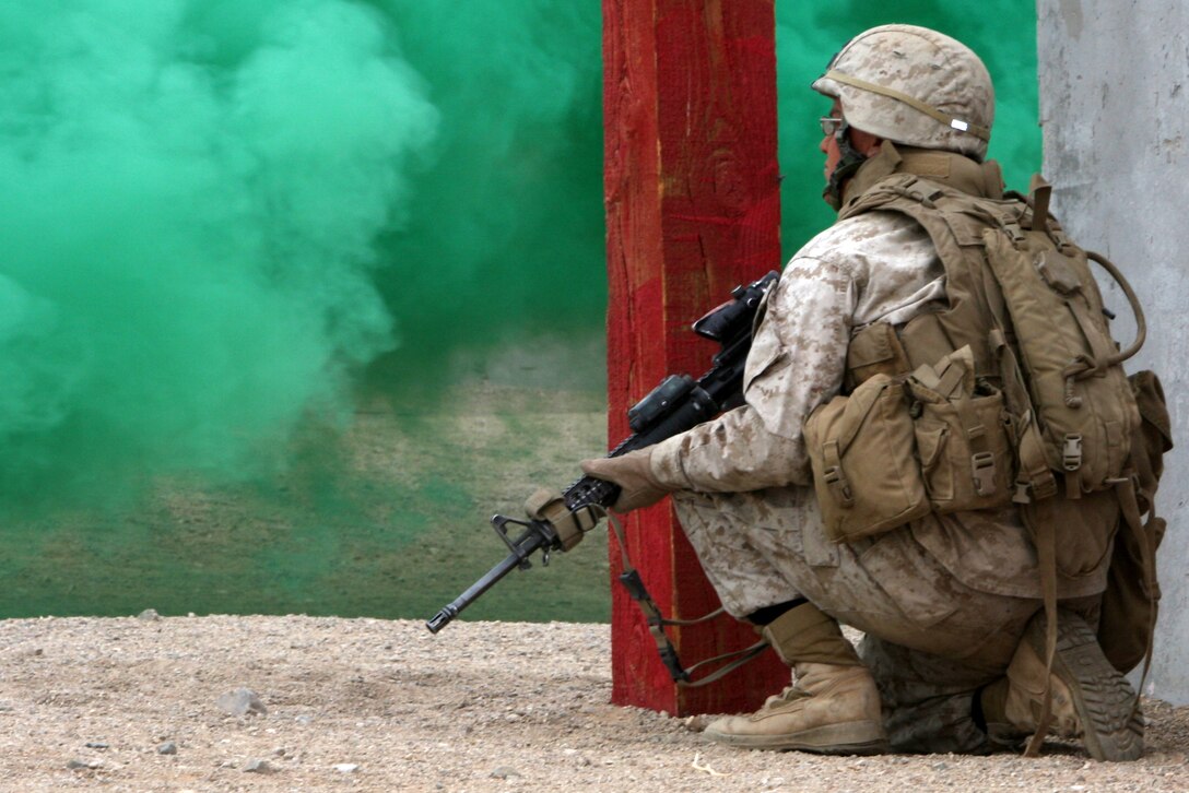 A Marine with Company G, 2nd Battalion, 7th Marine Regiment, provides security as his fellow Marines conduct a raid on the Combat Center's Range 205 Nov. 11. This training was the last the company will undergo before their January deployment with the 31st Marine Expeditionary Unit.