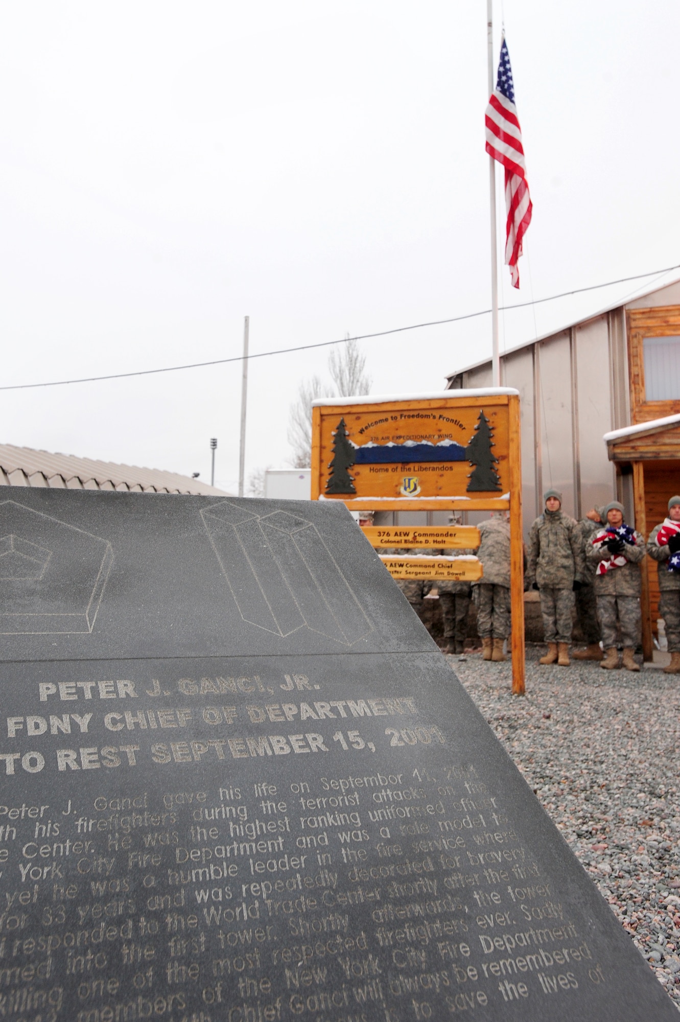 TRANSIT CENTER AT MANAS, Kyrgyzstan -- Airmen raise an American flag over Manas in honor of fallen N.Y. Fire Chief Peter Ganci Jr. during a ceremony on Veteran's Day, 2009. The Ganci name will forever be inscribed in those who serve at Manas due to his selfless acts to save innocent lives in 2001. (U.S. Air Force photo/Senior Airman Steele C. G. Britton)