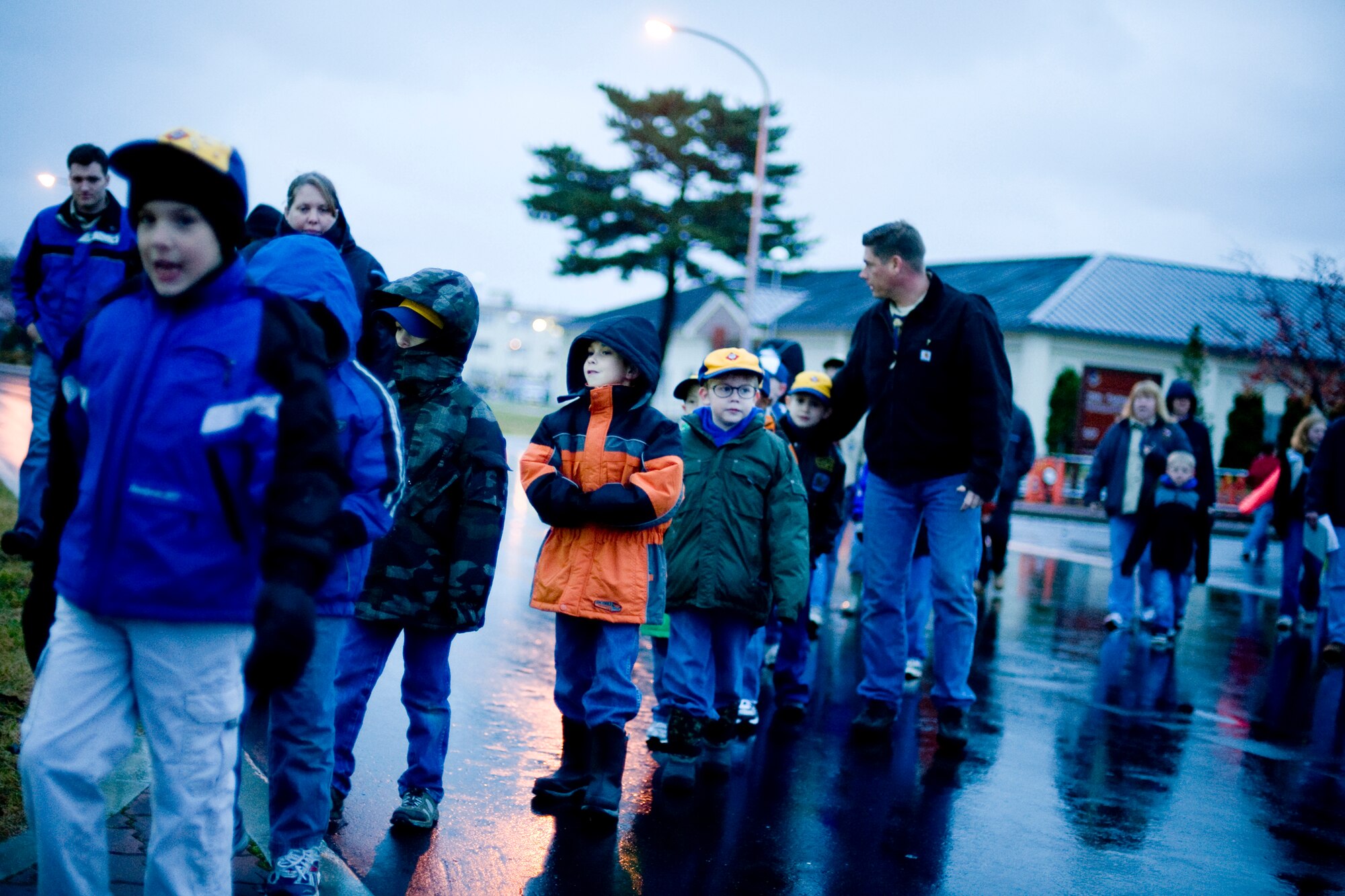 MISAWA AIR BASE, Japan -- Members of the Misawa Boy, Girl and Cub Scouts make their make to Risner Circle, Nov. 11, to participate in a Veterans Day retreat ceremony. Despite the cold, rainy weather, 29 children, along with their parents, observed the event in honor of the holiday. (U.S. Air Force photo/Senior Airman Jamal D. Sutter)
