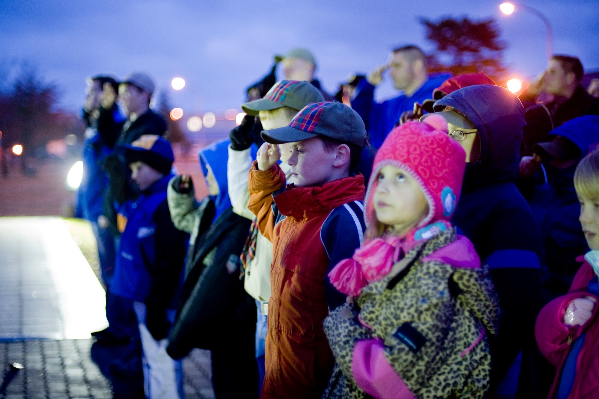 MISAWA AIR BASE, Japan -- Members of the Misawa Boy, Girl and Cub Scouts salute during a Veterans Day retreat ceremony Nov. 11 at Risner Circle. Participating in the ceremony was a chance for many of the scouts to learn how to fold a flag. (U.S. Air Force photo/Senior Airman Jamal D. Sutter)