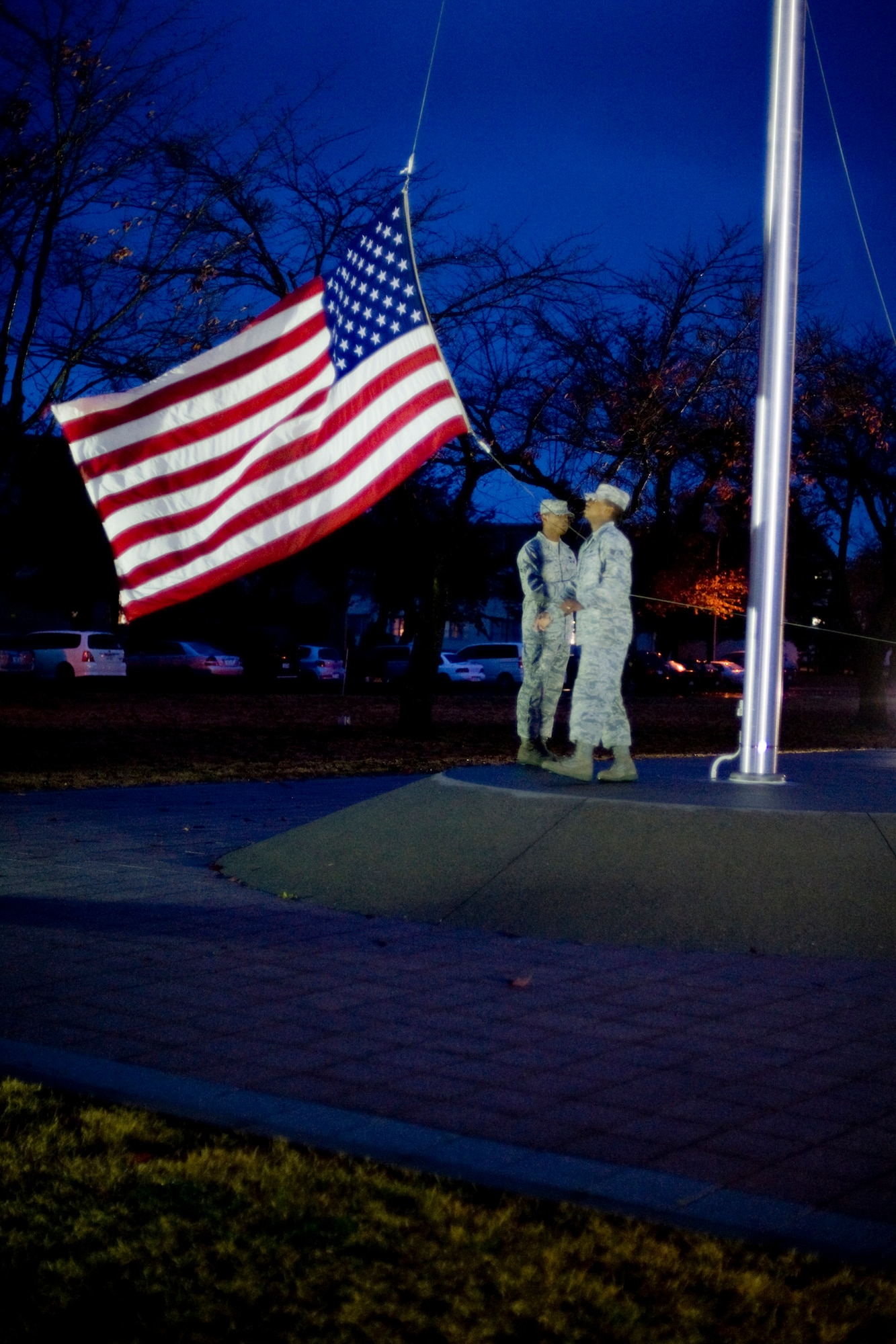 MISAWA AIR BASE, Japan -- Airman 1st Class Travis Yearty and Senior Airman Keyone Cropper, Misawa honor guardsmen, retire the American flag during a Veterans Day retreat ceremony Nov. 11 at Risner Circle. The ceremony offered a time to reflect on and honor U.S. military veterans. (U.S. Air Force photo/Senior Airman Jamal D. Sutter)