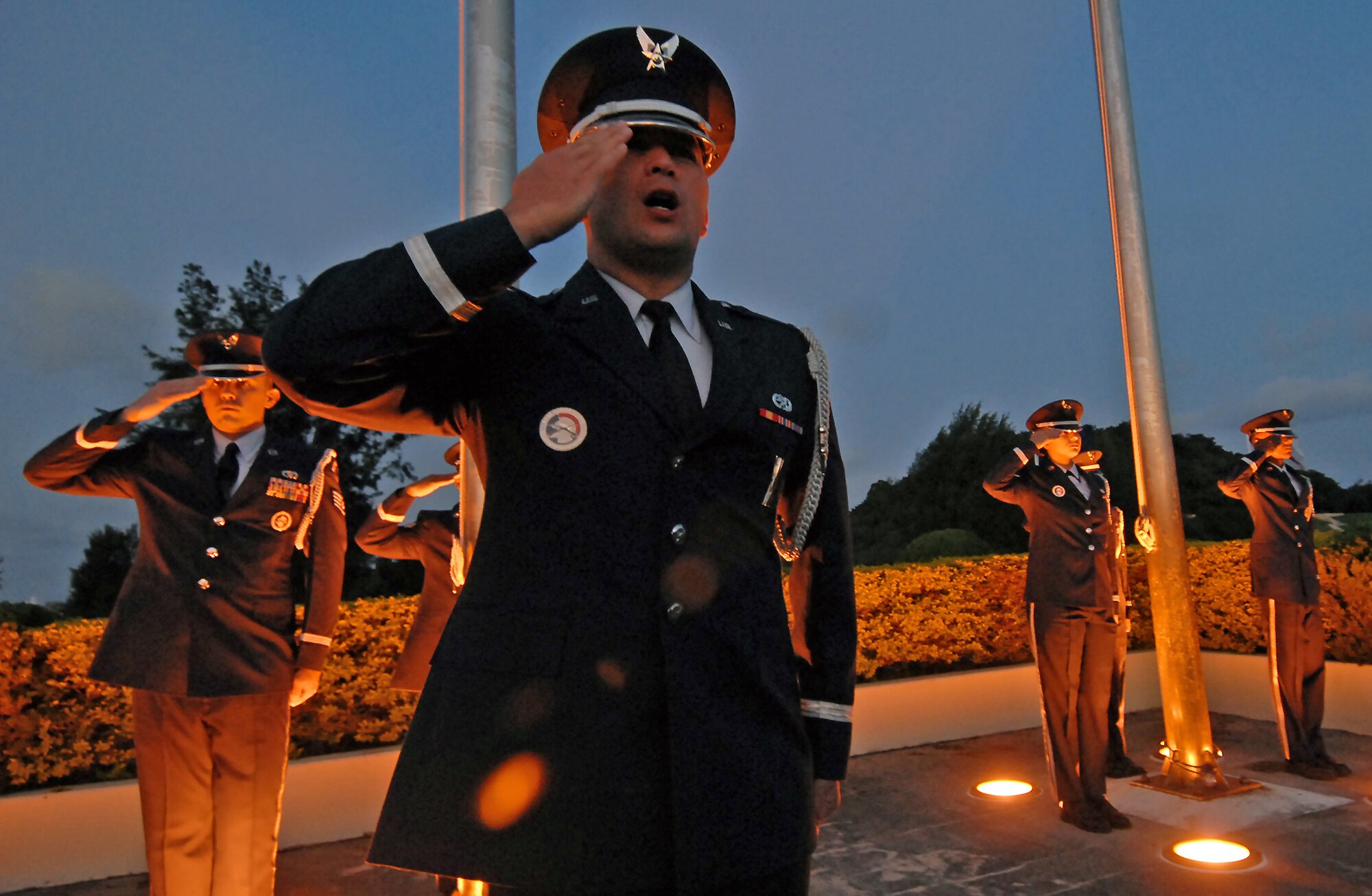 (Center) 1st Lt. Nicolas Schaeffer, 18th Munitions Squadron systems flight commander and Kadena honor guard assistant officer-in-charge, issues orders to his teammates as they prepare for a ceremony in early morning hours of Veteran's Day. The Kadena honor guard and approximately 200 servicemembers representing all military branches paid tribute to the Nov. 11 holiday honoring those who served in the military - both past and present. (Air Force/Staff Sgt. Jason Lake)