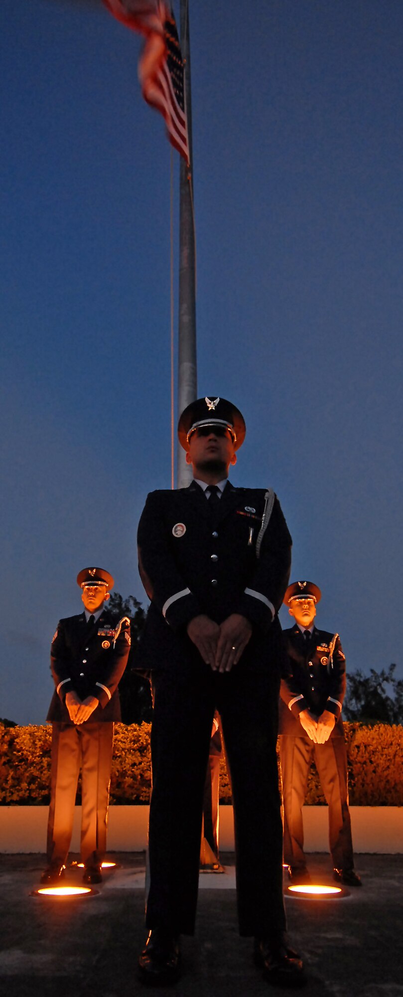 (Center) 1st Lt. Nicolas Schaeffer, 18th Munitions Squadron systems flight commander and Kadena honor guard assistant officer-in-charge, prepares teammates Staff Sgt. Kristofer Talbott and Airman 1st Class Christopher Gangloff for performance during the early morning hours of Veteran's Day. The Kadena honor guard and approximately 200 servicemembers representing all military branches paid tribute to the Nov. 11 holiday honoring those who served in the military - both past and present. (Air Force/Staff Sgt. Jason Lake)