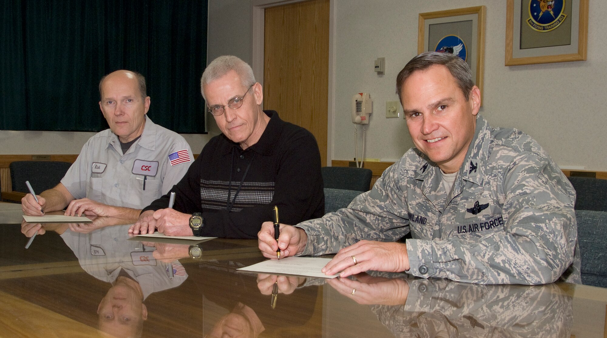 International Association of Machinists and Aerospace Workers Local Lodge 898 President Rick Boardman, CSC Applied Technologies LLC Deputy Program Manager James Duke and 71st Flying Training Wing Commander Col. Chris Nowland sign a statement of commitment Oct. 27 to the principles of the Voluntary Protection Program at Vance Air Force Base, Okla. The VPP was launched in the summer of 2009 here and is programmed to continue through several implementation phases in the next two years. (U.S. Air Force photo/Terry Wasson)