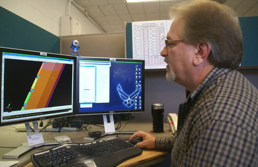 Daniel Catalano, a senior machinist with Aerospace Testing Alliance, looks at a Computer Aided Design drawing he made based on a modified older probe-rake for an upcoming test in AEDC's T-3 test cell. Catalano submitted the suggestion on how to re-engineer the probe rake assembly in a way that will result in a cost savings of more than $280,000. (Photo by Philip Lorenz III)