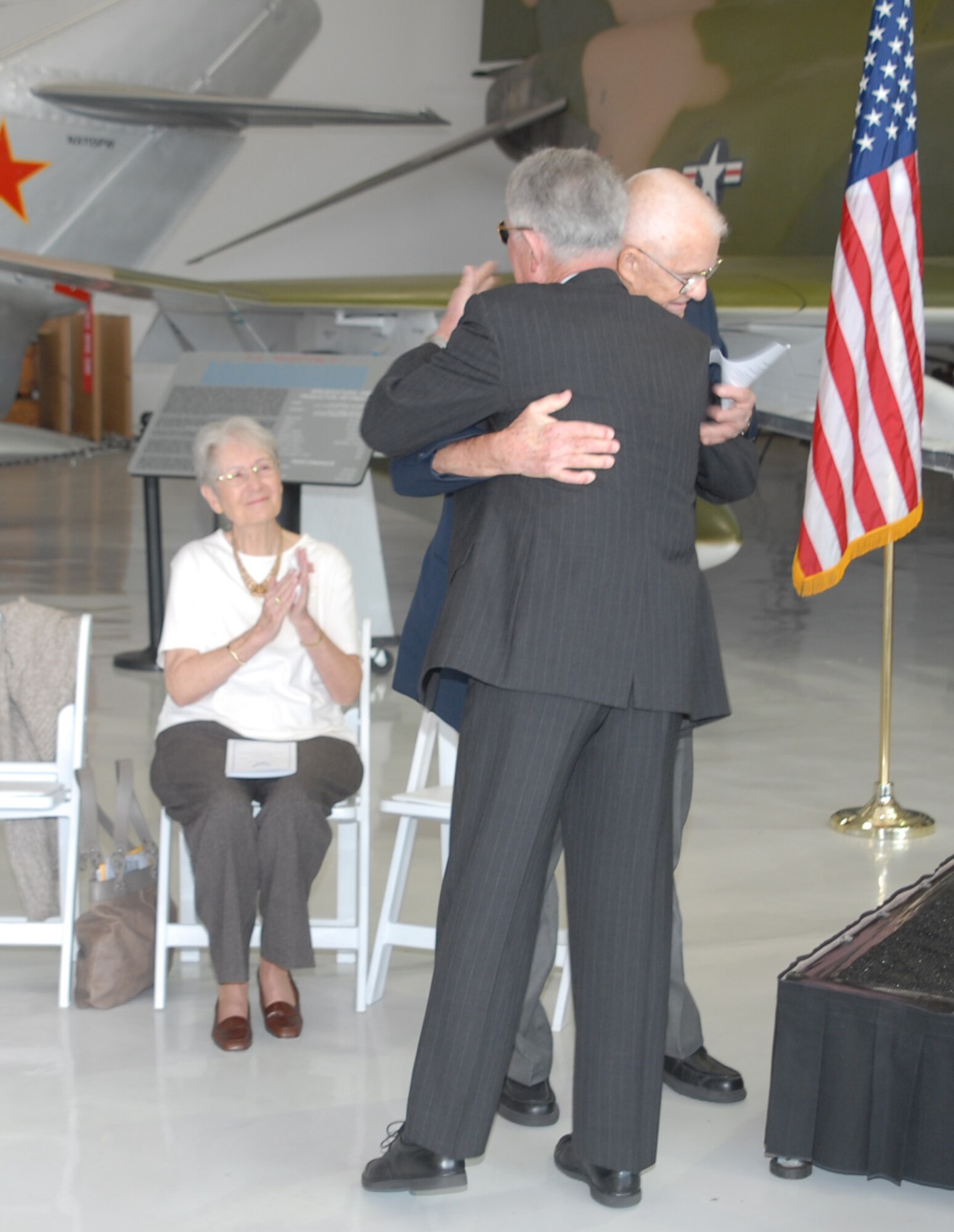 Retired Air Force Col. James Hivner and retired Navy Cmdr. Rick Tolley embrace Oct. 11 at the Cavanaugh Flight Museum. Commander Tolley took on the task of returning a ring confiscated from a North Vietnamese prisoner of war in 1965. Colonel Hivner had not seen the ring in over 44 years. (U.S. Air Force photo/Lou Anne Sledge)