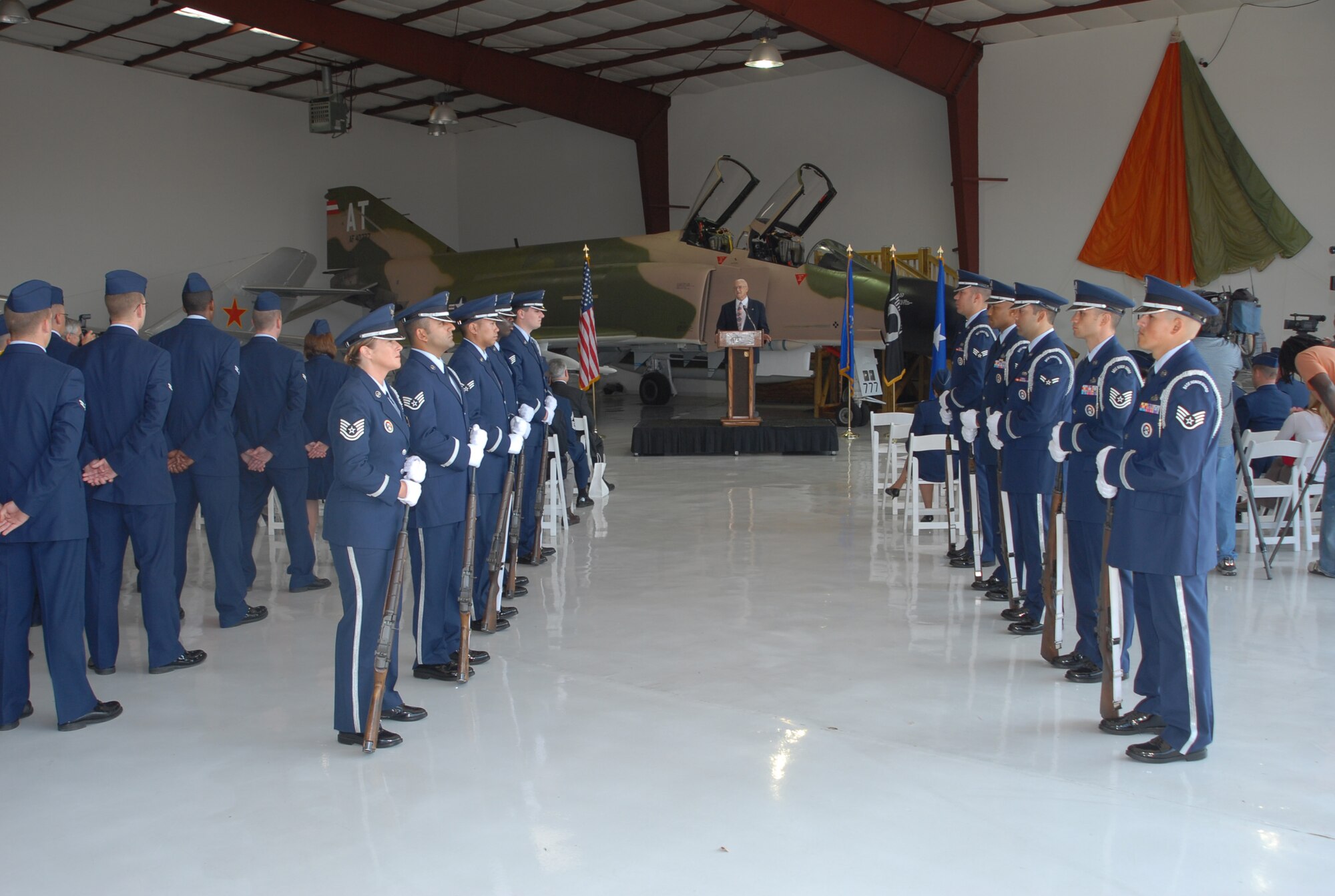 Retired Air Force Col. James Hivner addresses an audience of Airmen, family and friends Nov. 11 at the Cavanaugh Flight Museum in Addison, Texas, after receiving a ring that was confiscated by the North Vietnamese in 1965. Colonel Hivner was surprised by the turnout, but also gracious that so many people took interest. (U.S. Air Force photo/Lou Anne Sledge)