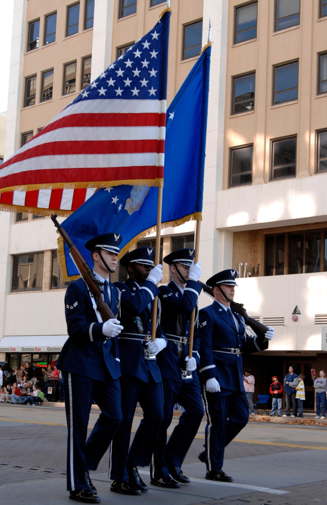 Airmen from the McConnell Air Force Base, Kan., Honor Guard lead the Wichita, Kan., Veterans Day Parade, Nov. 7, 2009. The parade route covered six blocks of downtown Wichita. (U.S. Air Force photo/Senior Airman Laura Suttles)
