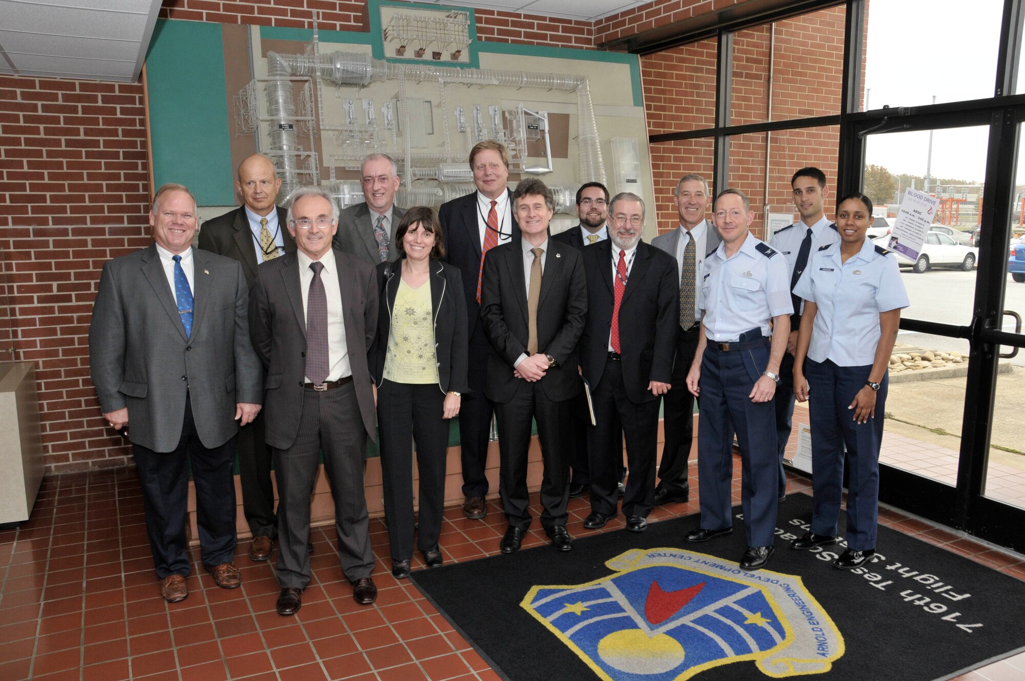 From left to right:  Arnold Engineering Development Center (AEDC) Export Control Officer Mackie Snipes, AEDC Senior Engineer Jack Walters, Jean-Claude Traineau (ONERA), Stephen Wolf (ONERA), and Florence Roudolff (ONERA), Mike George (NASA), Patrick Wagner (ONERA), Mike Wetzel, Armaments Cooperation Division, Deputy Under Secretary of the Air Force (SAF/IAPQ), AEDC Technical Director of the Plans and Programs Directorate Tom Best, ATA Director of Test and Evaluation Philip Stich, AEDC Vice Commander Col. Eugene Mittuch, 716th Test Squadron’s Capt. Brandon Herndon and 2nd Lt. Charmeeka Scroggins gathered for a group photo in the lobby of Propulsion Wind Tunnel Facility during the French group’s recent visit to AEDC. Jean-Claude Traineau is the director of the Le Fauga-Mauzac Wind Tunnel Department, ONERA. Wagner is the head of Computing, Engineering and Testing Facilities at ONERA. Florence Roudolff is the director of the Design, Engineering and Manufacturing department in ONERA's Computing, Engineering and Testing Facilities unit. (Photo by Rick Goodfriend)