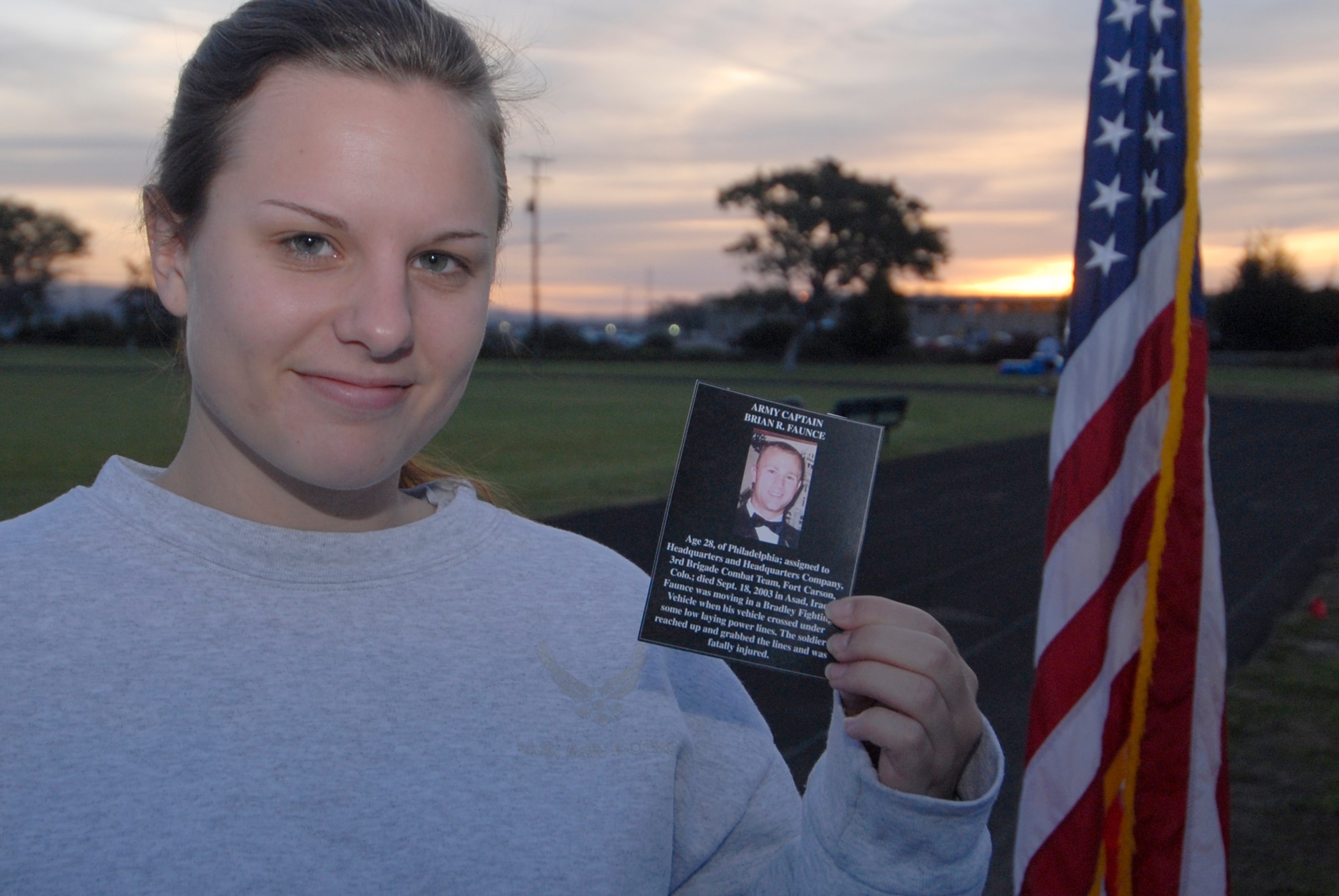 VANDENBERG AIR FORCE BASE, Calif. -- Senior Airman Melissa Brannon holds up the biography of a fallen servicemember she ran for during The Run to Remember. The Run to Remember honors all servicemembers who lost their life in Operations Iraqi and Enduring Freedom. (U.S. Air Force photo/Airman 1st Class Angelina Drake)  