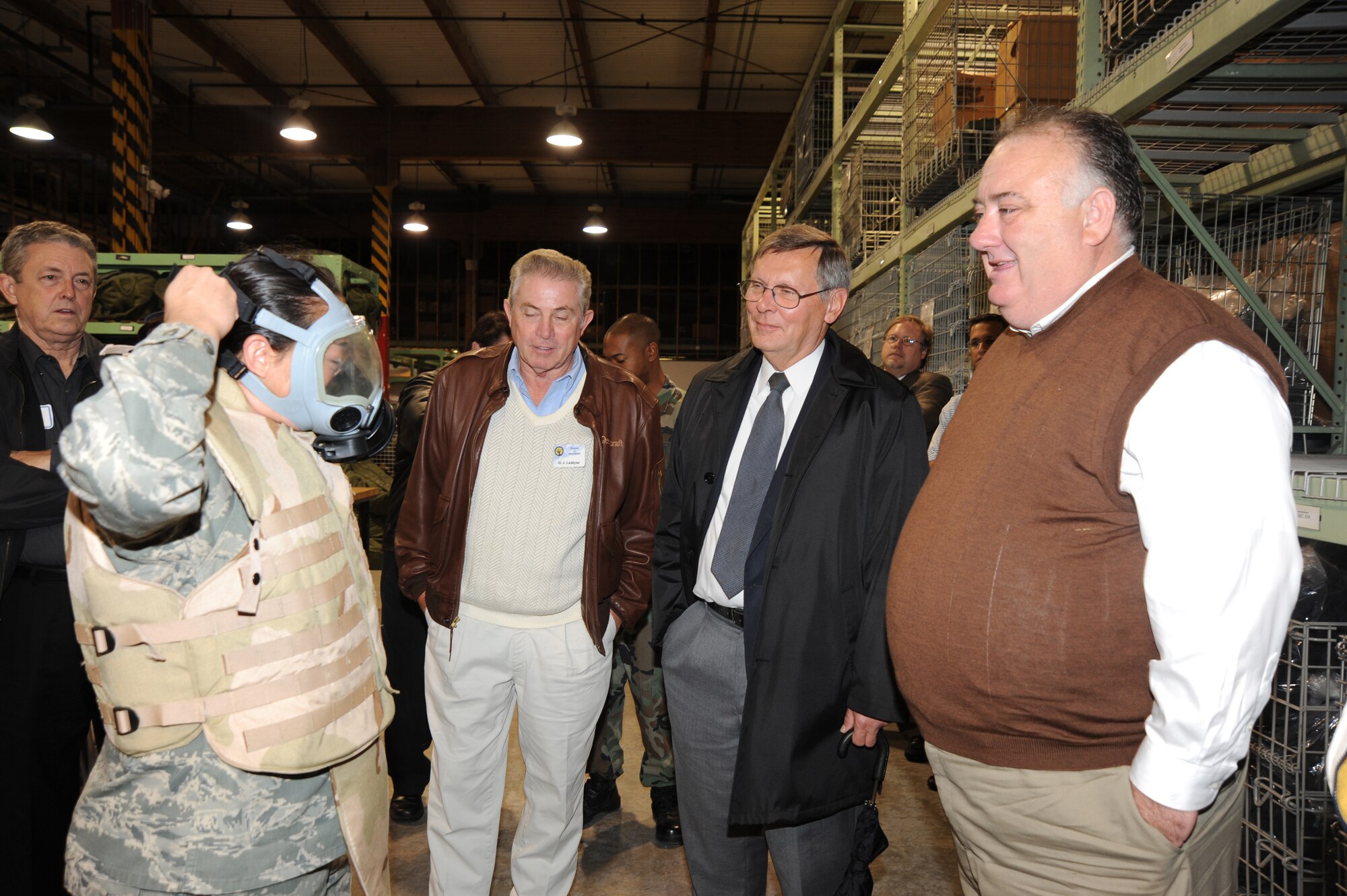 Airman Megan Tetreault, 22nd Logistics Readiness Squadron, demonstrates how to wear a chemical mask for a group of honorary commanders during an honorary commander orientation tour Oct. 29, 2009, at McConnell Air Force Base, Kan. The honorary commander program is designed to increase civilian understanding of the Air Force and Team McConnell’s mission. (U.S. Air Force photo by Tech. Sgt. Chyrece Campbell) 
