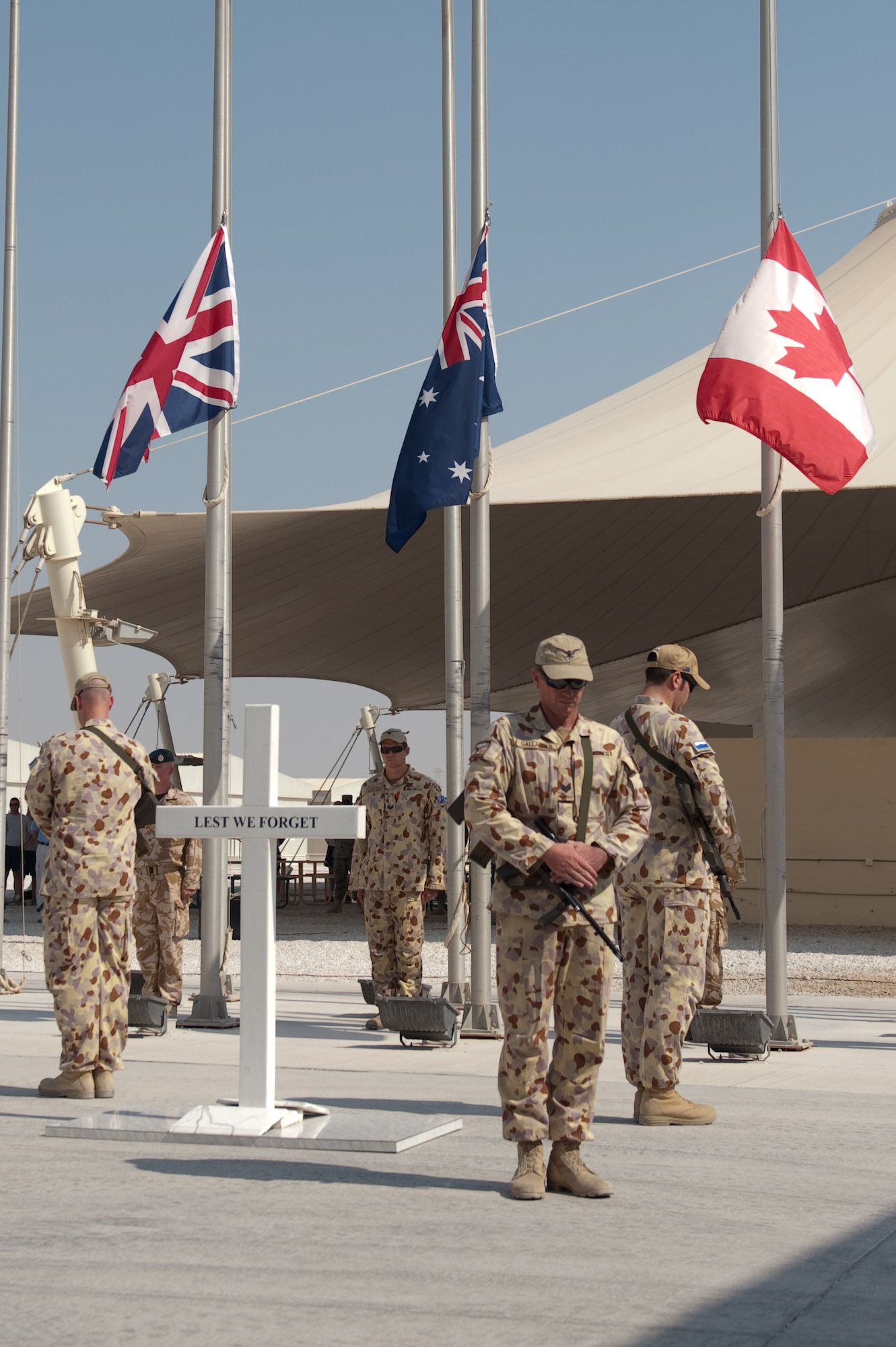 Royal Australian Air Force honor guard members provide honors during a Remembrance Day ceremony Nov. 11, 2009, at a deployed location in Southwest Asia. Military personnel from the United Kingdom, Australia, Canada, France, and the United States commemorated the sacrifice of their fellow military personnel from past and current conflicts. (U.S. Air Force photo/Staff Sgt. Robert Barney) 