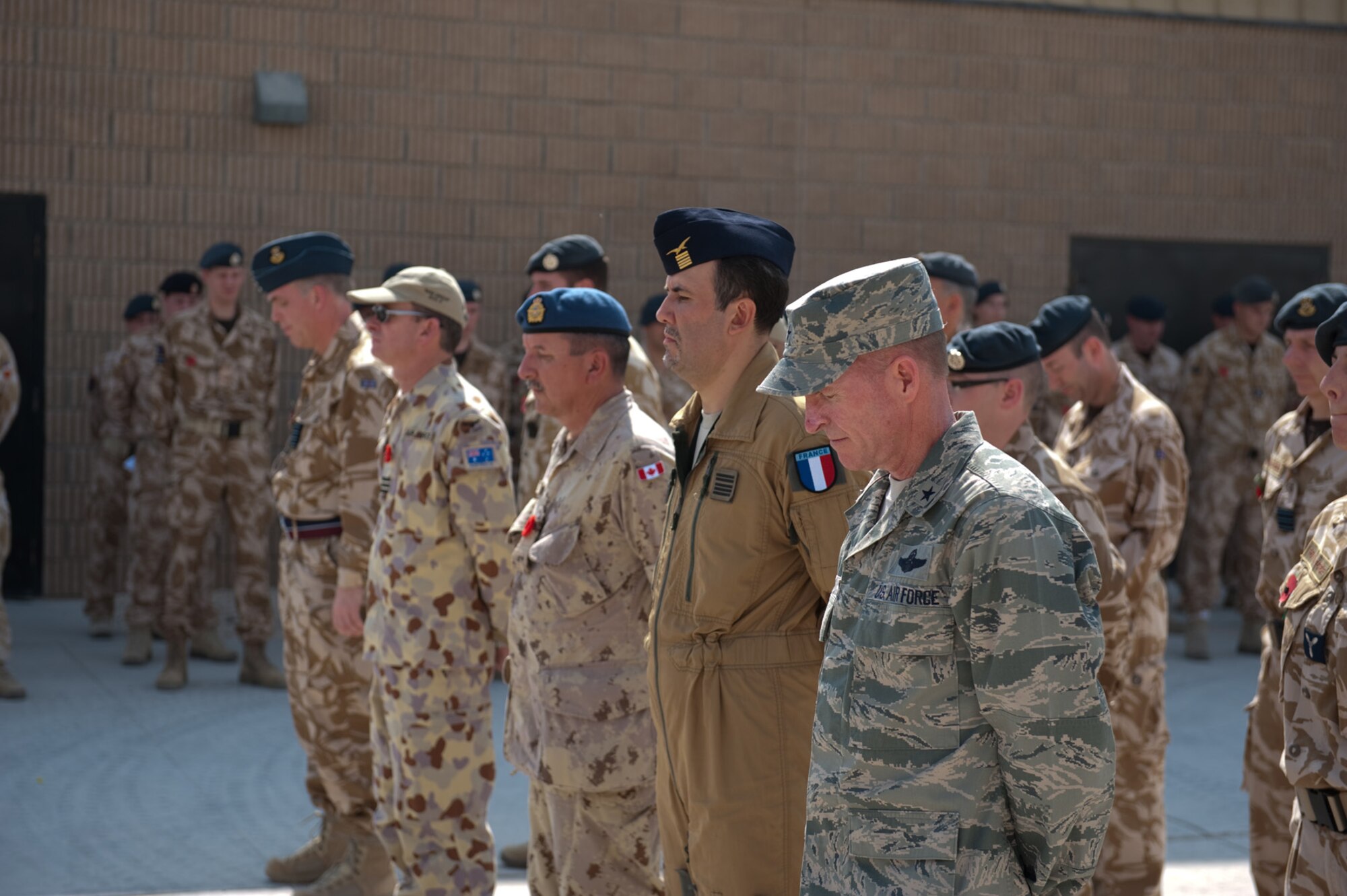 Military personnel from the United Kingdom, Australia, Canada, France, and the United States pause for a moment of silence during a Remembrance Day ceremony, Nov. 11, 2009, at a deployed location in Southwest Asia. Military personnel commemorated the sacrifice of their fellow military personnel from past and current conflicts. (U.S. Air Force photo/Staff Sgt. Robert Barney) 