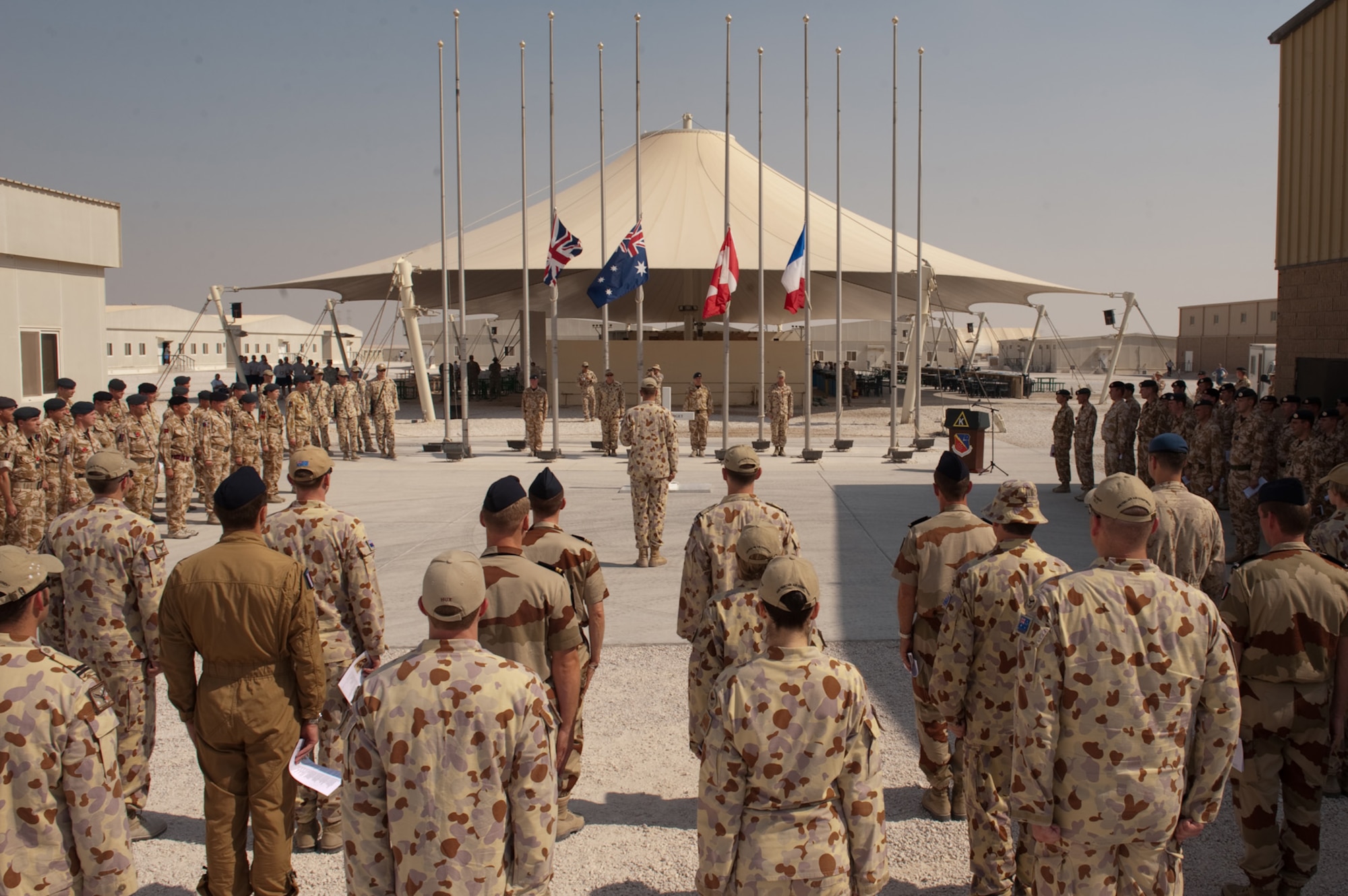 Military personnel from the United Kingdom, Australia, Canada, France, and the United States form into ranks for a Remembrance Day ceremony, Nov. 11, 2009, at an undisclosed location in Southwest Asia. Military personnel took time from their duties to commemorate the sacrifice of fellow military personnel from past and current conflicts. (U.S. Air Force photo/Staff Sgt. Robert Barney) 