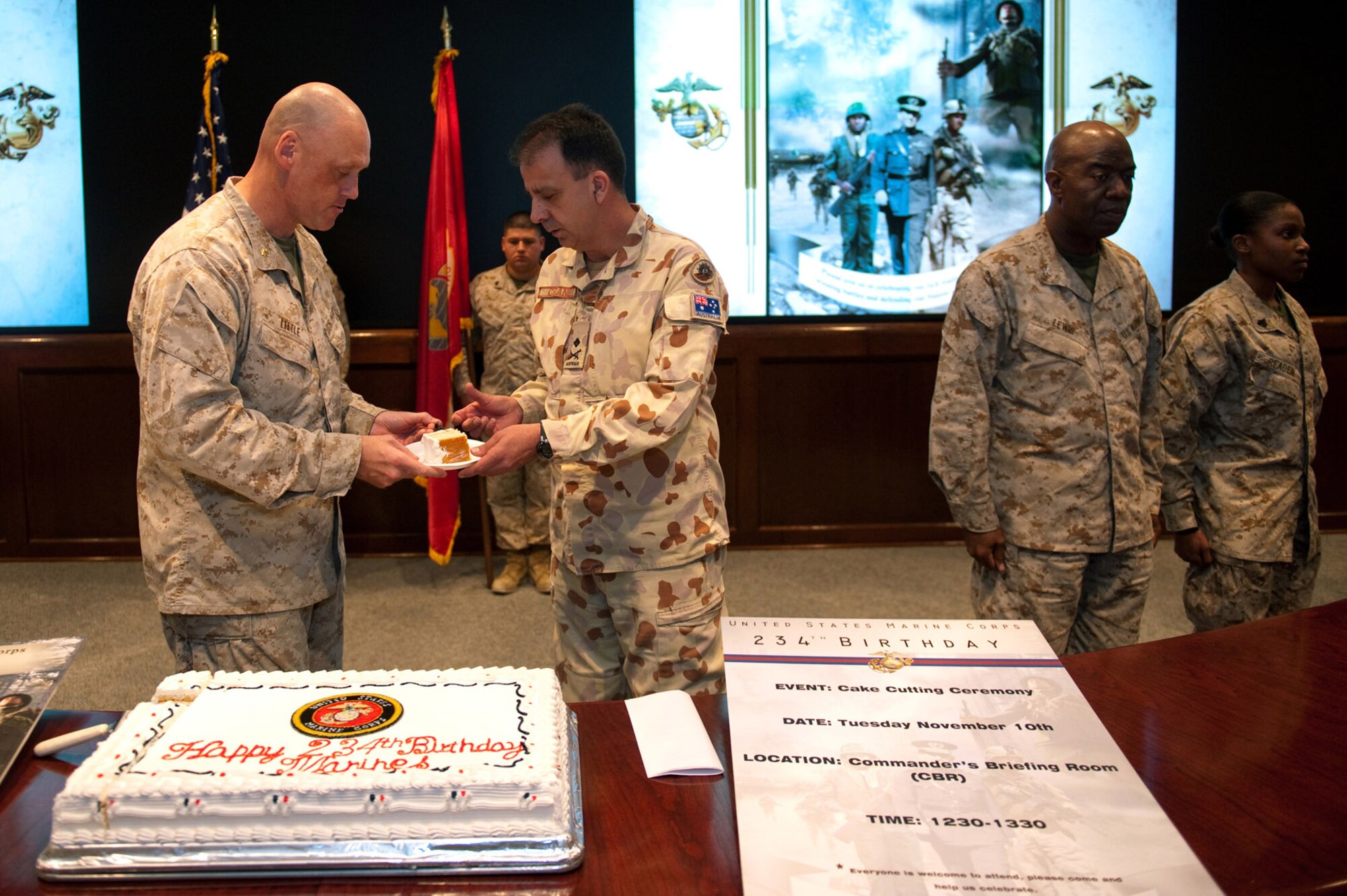 U.S. Marine Corps Major Tom Little serves the guest of honor, Australian Army Maj. Gen. Michael Crane, the first piece of birthday cake during a celebration of the U.S. Marine Corps' 234th birthday, Nov. 10, 2009, in Southwest Asia. (U.S. Air Force photo/Staff Sgt. Robert Barney) 