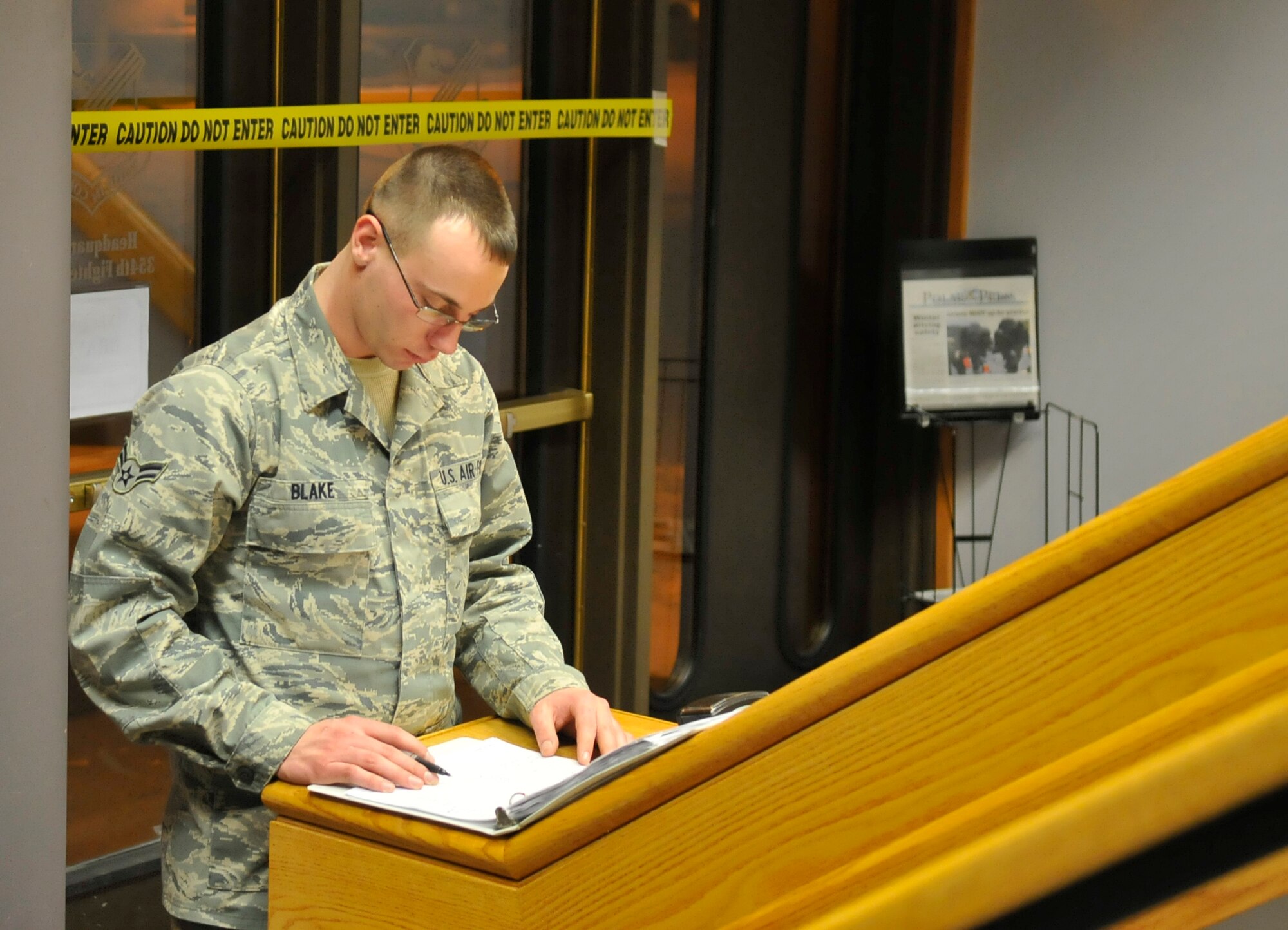 Airman 1st Class Christopher Blake inspects the entry and exit log during the operational readiness exercise to ensure accountability Nov. 6, 2009, Eielson Air Force Base, Alaska. It is one of his duties to remind people to sign in and out as they enter and exit the building. In addition, he secures the perimeter of the building as well as the inside and outside. The security team is the first line of defense for the occupants and equipment. (U.S. Air Force/ Airman 1st Class Janine Thibault)