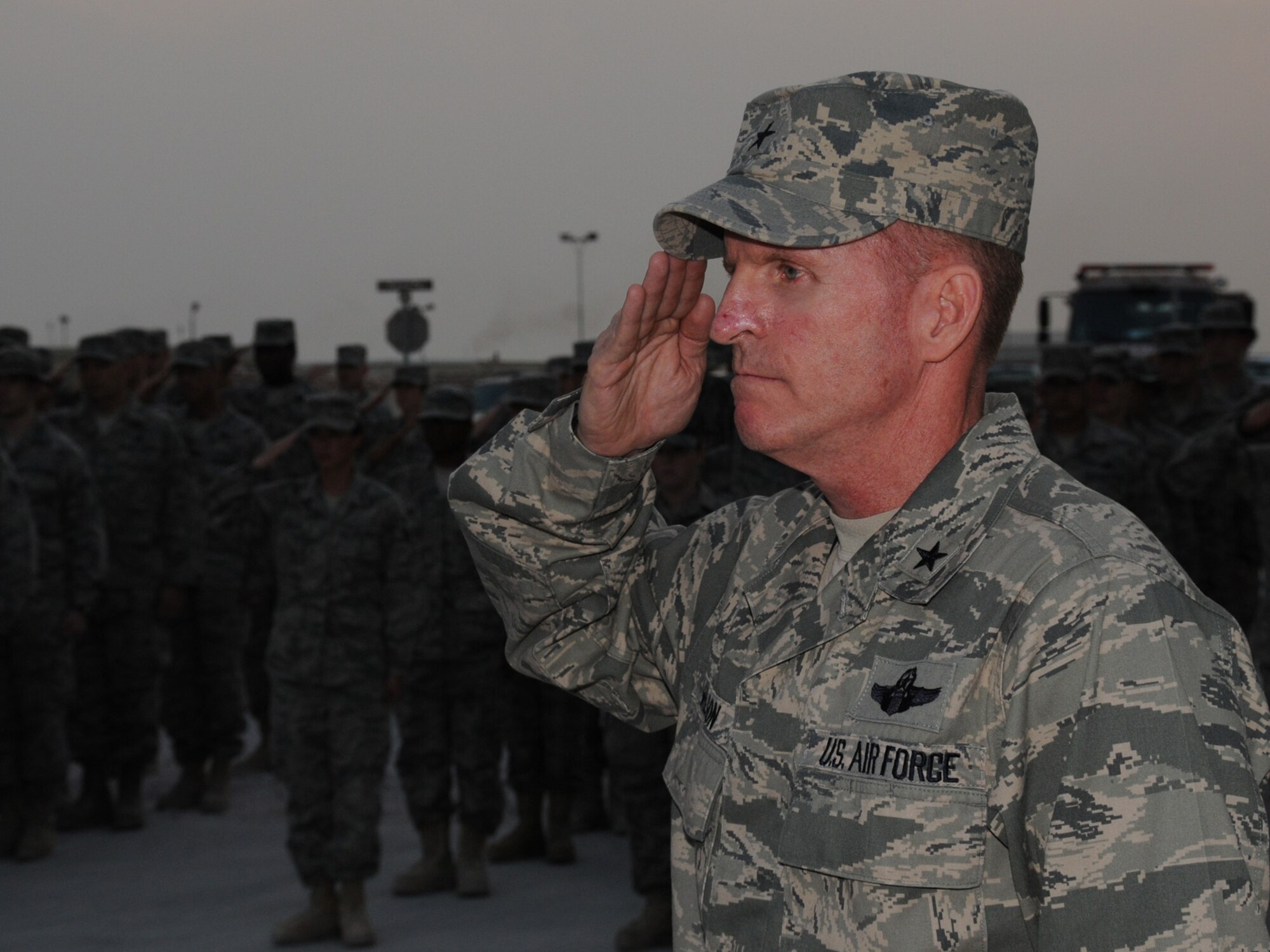 Brig. Gen. Stephen Wilson, 379th Air Expeditionary Wing commander, renders a salute to the U.S. flag as it is lowered during a Veterans' Day retreat ceremony, Nov. 11, 2009, at a deployed location in Southwest Asia. Veterans' Day, also known as Armistice Day and Remembrance Day in other parts of the world, commemorates the end of World War I and honors past and present servicemembers. (U.S. Air Force photo/Tech. Sgt. Jason W. Edwards)