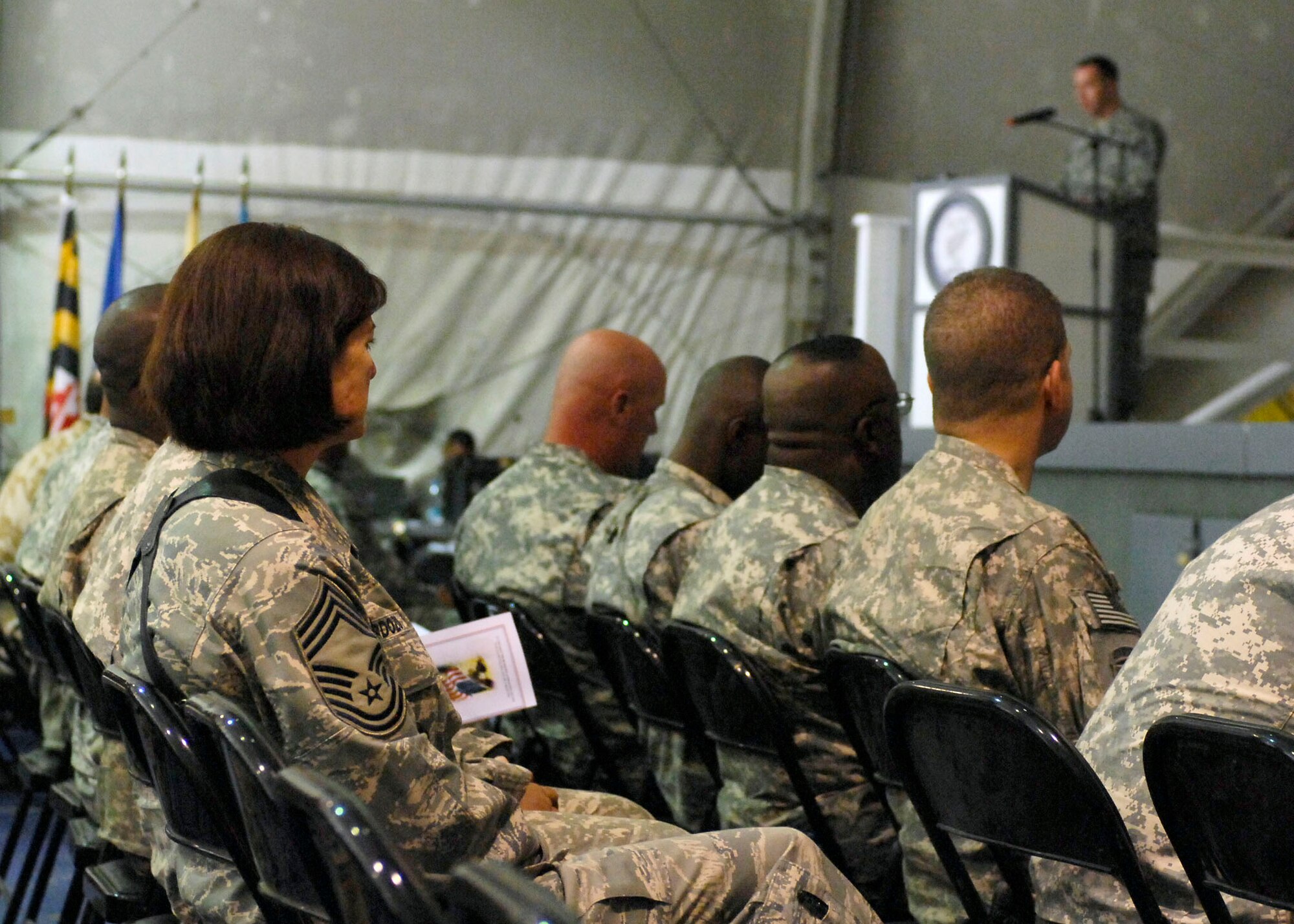BAGRAM AIRFIELD, Afghanistan -- Chief Master Sgt. Stephanie Cardozo with Joint Task Force MED east/455th Expeditionary Medical Group, listens to Army Sgt. First Class Raleigh Sell, the protocol non-commissioned officer in charge from Combined Joint Task Force 82.  Sergeant Sell spoke at the Veteran's Day Ceremony Nov. 11, 2009.  Chief Cardozo hails from Port Jervis, N.Y.  Sergeant Sell is deployed from Fort Bragg, N.C., and hails from Griffith, Ind.  (U.S. Air Force photo/Senior Airman Felicia Juenke)