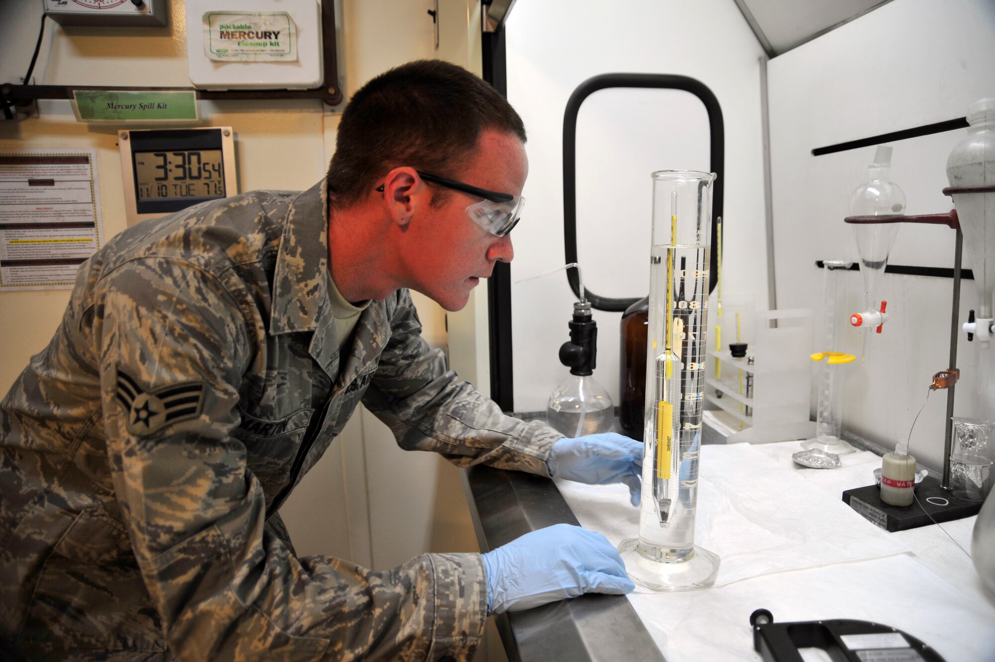SOUTHWEST ASIA - Senior Airman Levi Martin, 380th Expeditionary Logistics Readiness Squadron fuel laboratory technician, reads the measurement on a hydrometer in a beaker of jet fuel Nov. 10, 2009. Airman Martin is deployed from Dover Air Force Base, Del., and grew up in Crestview, Fla. (U.S. Air Force photo/Tech. Sgt. Charles Larkin Sr)