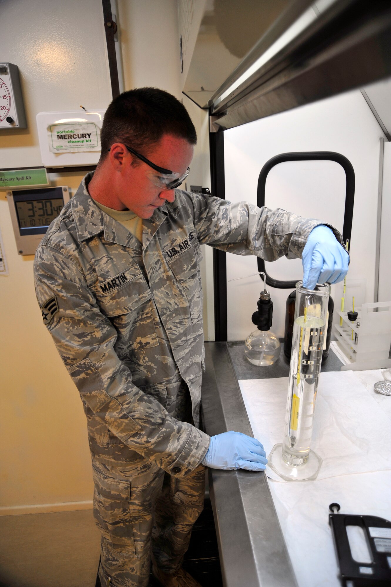 SOUTHWEST ASIA - Senior Airman Levi Martin, 380th Expeditionary Logistics Readiness Squadron fuel laboratory technician, drops a hydrometer in a beaker of jet fuel to test the fuel density Nov. 10, 2009. Airman Martin is deployed from Dover Air Force Base, Del., and grew up in Crestview, Fla. (U.S. Air Force photo/Tech. Sgt. Charles Larkin Sr)