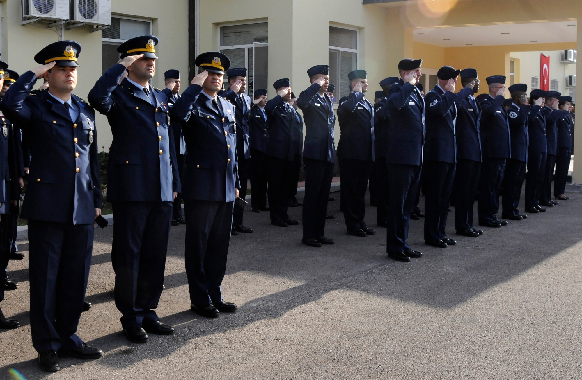 Turkish and American Air Force members salute during a moment of silence during the Ataturk Memorial Day Ceremony, Tuesday, Nov. 10, 2009 in front of the 10th Tanker Base Command Headquarters. The ceremony was open to all members of the Incirlik community. (U.S. Air Force photo/Airman 1st Class Amber Ashcraft)