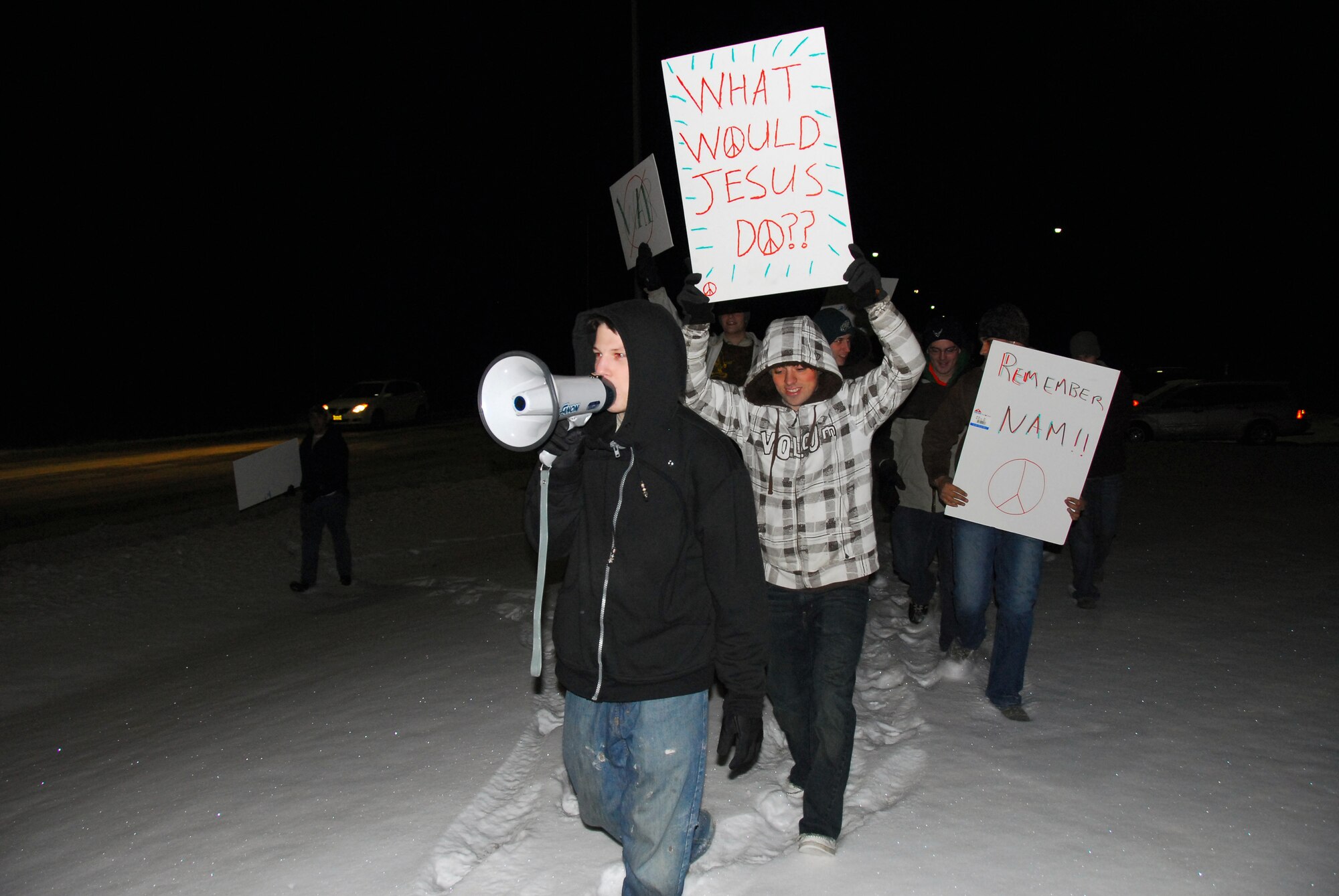 Airman 1st Class Brian Cook leads other 354th Fighter Wing Airmen to simulate a protest at the main gate during an exercise inject to test security forces response Nov. 5, 2009 at Eielson Air Force Base, Alaska. The event was one of dozens throughout the week to help test and evaluate the wings agencies in their ability to respond to situations. Airman Cook is assigned to the 354th Aircraft Maintenance Squadron. (U.S Air Force photo/Tech. Sgt. Shad Eidson)