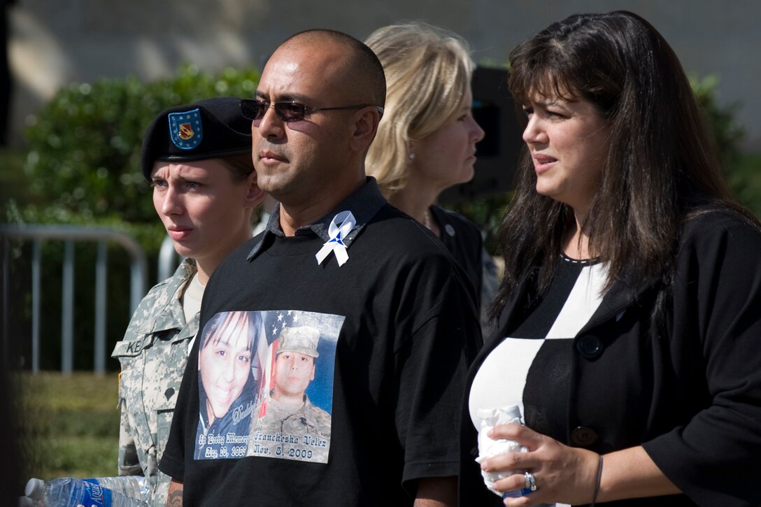 A family member of Army Pvt. Francheska Velez wears her photo on his shirt as he is escorted to his seat during a memorial ceremony honoring Velez and 12 others who were fatally shot during a Nov. 5 shooting rampage  in the Army processing station on  Fort Hood, Texas, Nov. 10, 2009. Velez was assigned to the 1st Battalion, 8th Cavalry Regiment, 2nd Brigade Combat Team, 1st Cavalry Division.