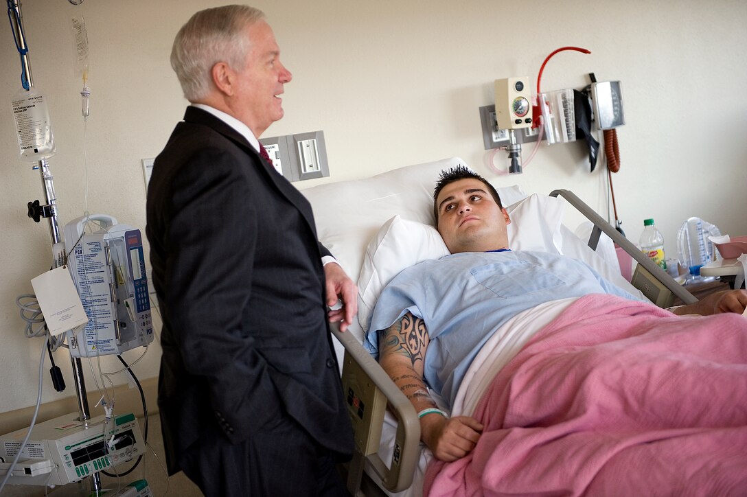 Secretary of Defense Robert M. Gates meets with Army Spec. Logan Michael Burnett, a reservist, in the hospital on Fort  Hood, Texas, Nov. 10, 2009.  Burnett was wounded during the mass shooting at the Army processing station on post on Nov. 5.