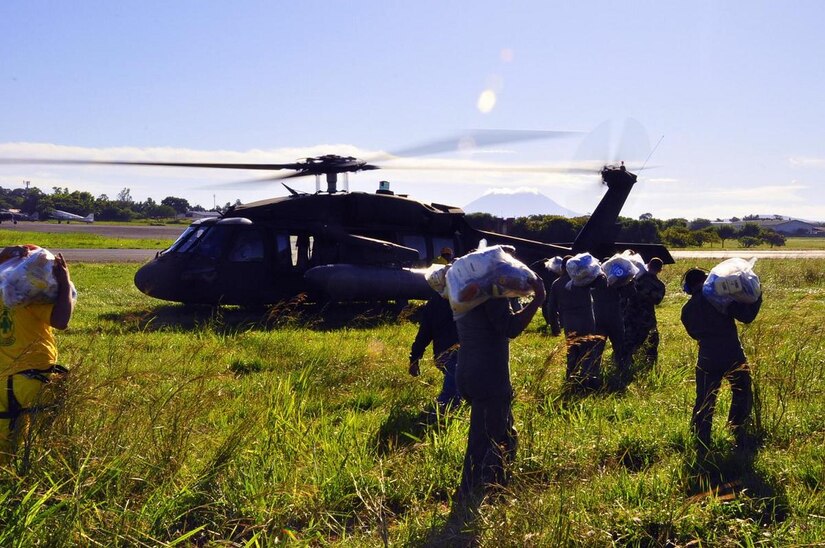 ILOPANGO, El Salvador -- Volunteers, Salvadoran air force and members of Joint Task Force-Bravo, based out of Soto Cano Air Base, Honduras, load food, water and other donated items onto an UH-60 Blackhawk Nov. 12 here. The JTF-Bravo members helped distribute more than 21,000 pounds of food, water, clothing and other hygiene products to villages of El Salvador that have been cut off by mudslides. The towns most affected by the Nov. 8 flooding were Verapaz, Guadalupe, Santa Maria Ostumas and San Vicente. These villages were completely cut off by damaged roads and bridges (U.S. Air Force photo/Staff Sgt. Chad Thompson).