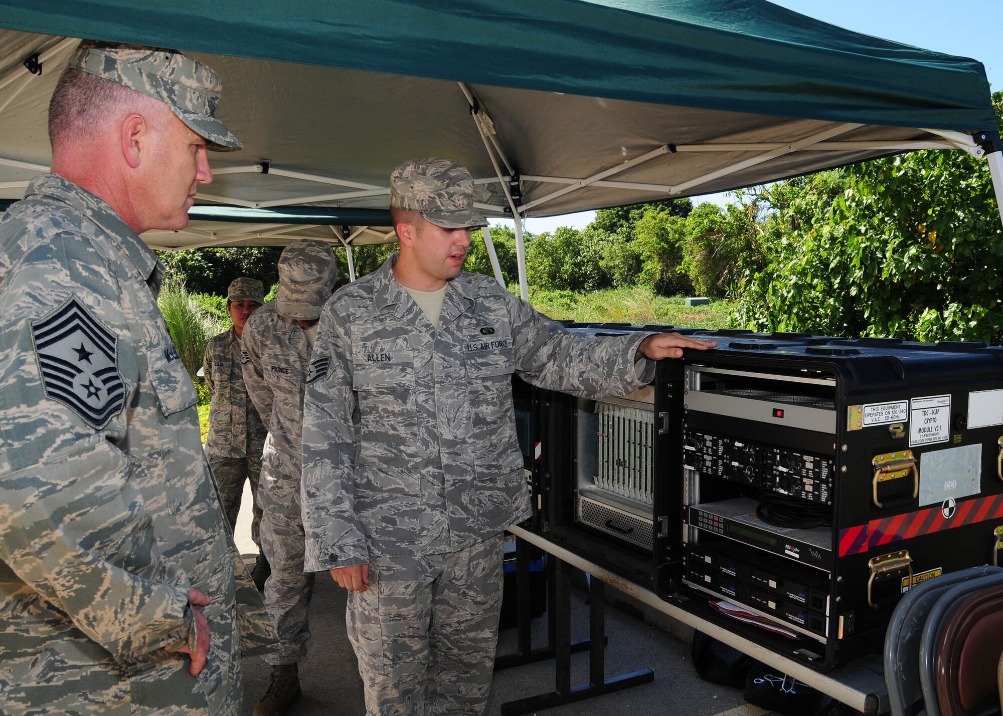 ANDERSEN AIR FORCE BASE, Guam - Staff Sgt. Brandon Allen, 644th Combat Communications Squadron, explains the capabilities and the essential communications equipment used during the bed down of a base to PACAF Command Chief Master Sgt. Brooke McLean during his visit here Nov. 9-10. (U.S. Air Force photo by Senior Airman Nichelle Anderson)