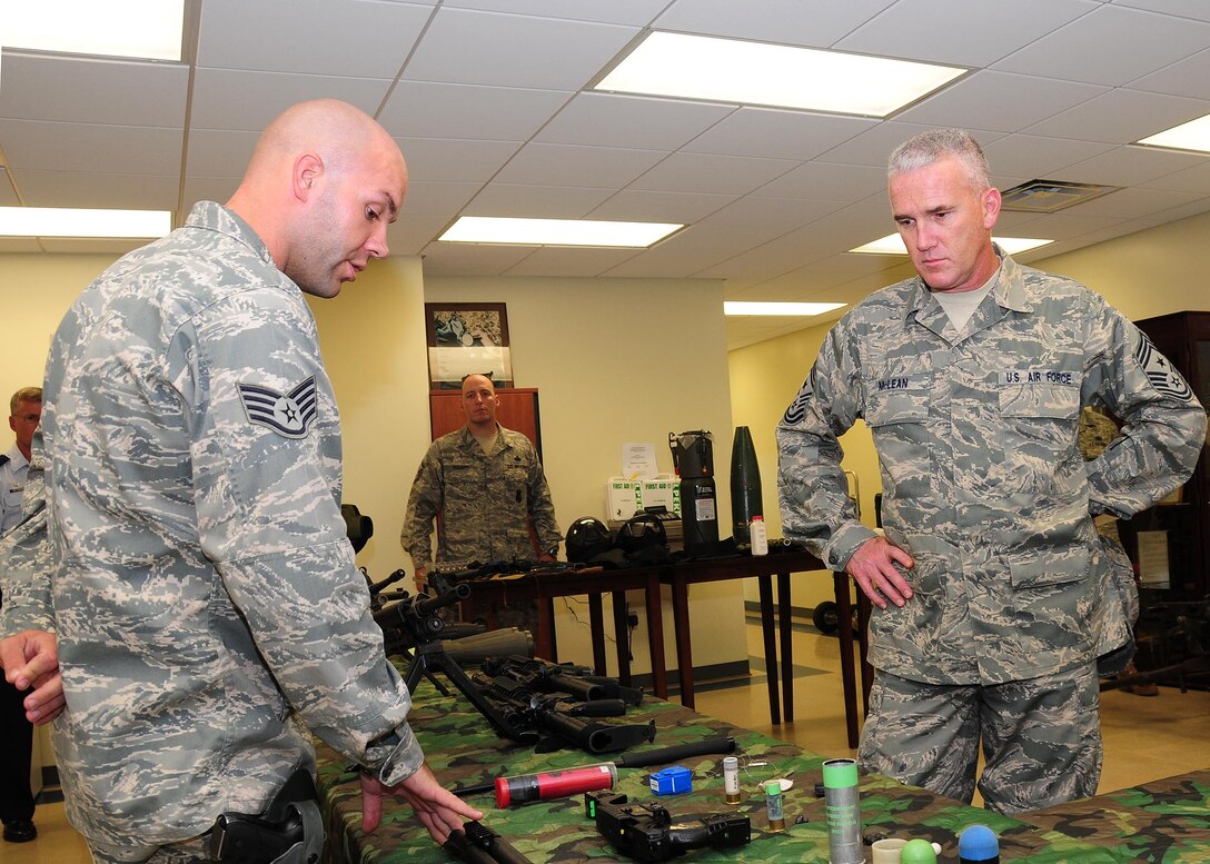 ANDERSEN AIR FORCE BASE, Guam - Staff Sgt. Craig Willits, 736th Security Forces Squadron, explains the weapons and simunitions used by the students attending the Pacific Regional Training Center's Commando Warrior pre-deployment training course to Pacific Air Forces Command Chief Brooke McLean here Nov. 10 during a site visit. This is Chief McLean's first visit to Andersen AFB as PACAF command chief. (U.S. Air Force photo by Senior Airman Nichelle Anderson)