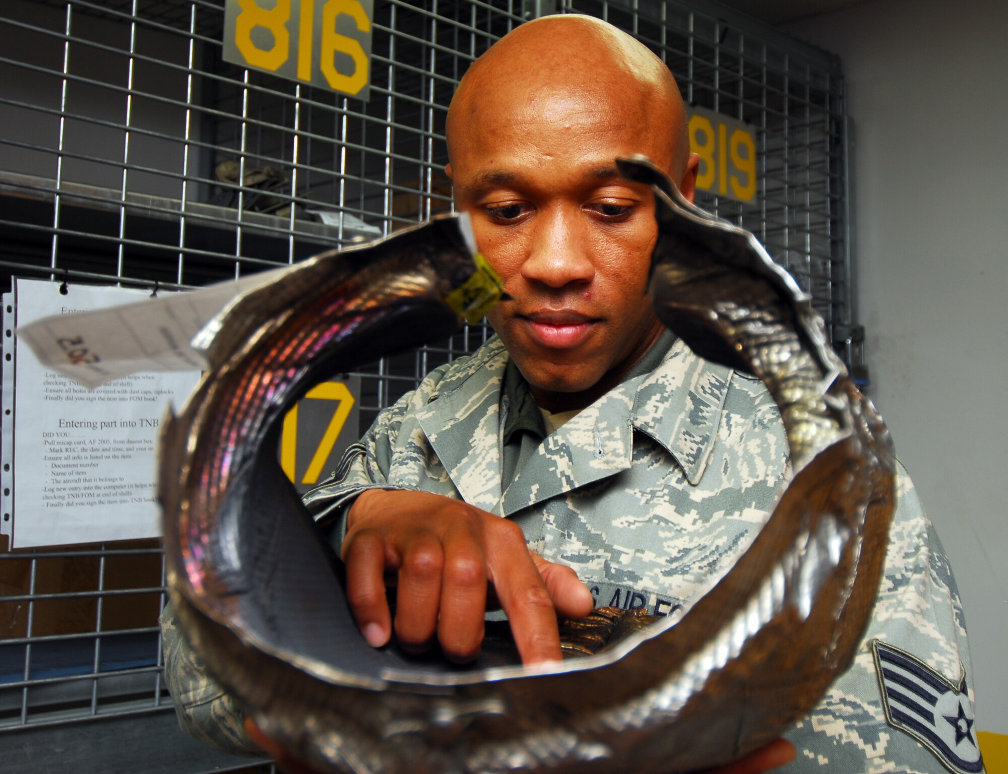 MISAWA AIR BASE, Japan—Staff Sgt. Anthony Pope, 14th Aircraft Maintenance Unit supply logistic technician, a native of Stone Mountain, Ga., inspects a jet fuel starter exhaust manifold, Nov. 12,  before placing it into a storage bin in the 14th AMU supply section. The supply section orders and stores parts for flightline maintainers. (U.S. Air Force photo/Staff Sgt. Phillip Butterfield)