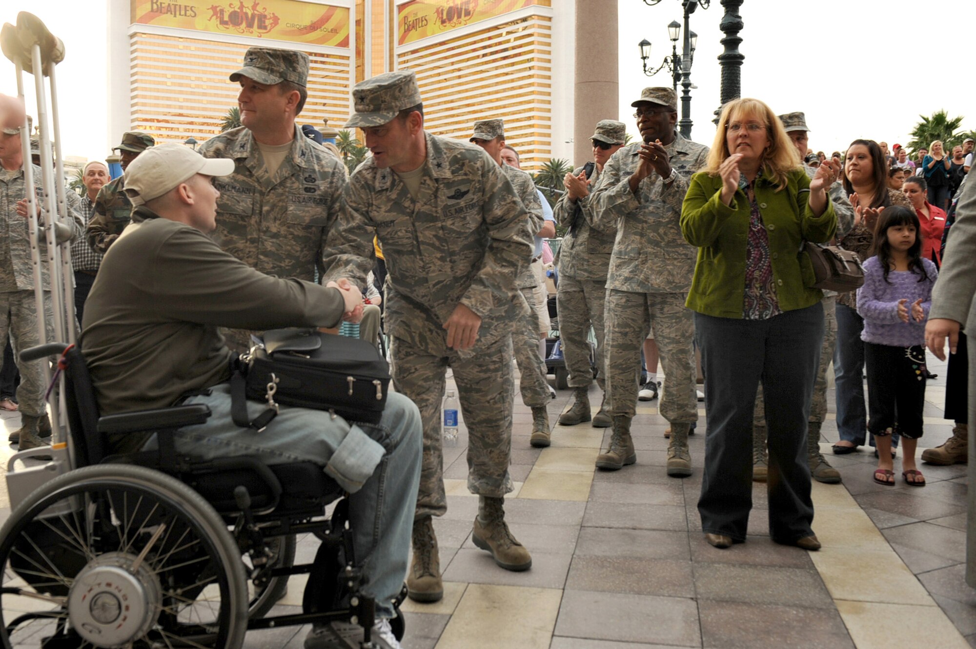 LAS VEGAS-- Brig. Gen. Russell Handy, 57th Wing commander, and Col. Steven Winklmann, 99th Air Base Wing vice commander, greet a wounded veteran during the Tribute to the Troops Nov. 11 at the Venetian Hotel and Casino.  More than 75 wounded warriors and their spouses were flown to Las Vegas for a weekend of relaxation and entertainment.  
(U.S. Air Force Photo by Airman 1st Class Jamie Nicley)