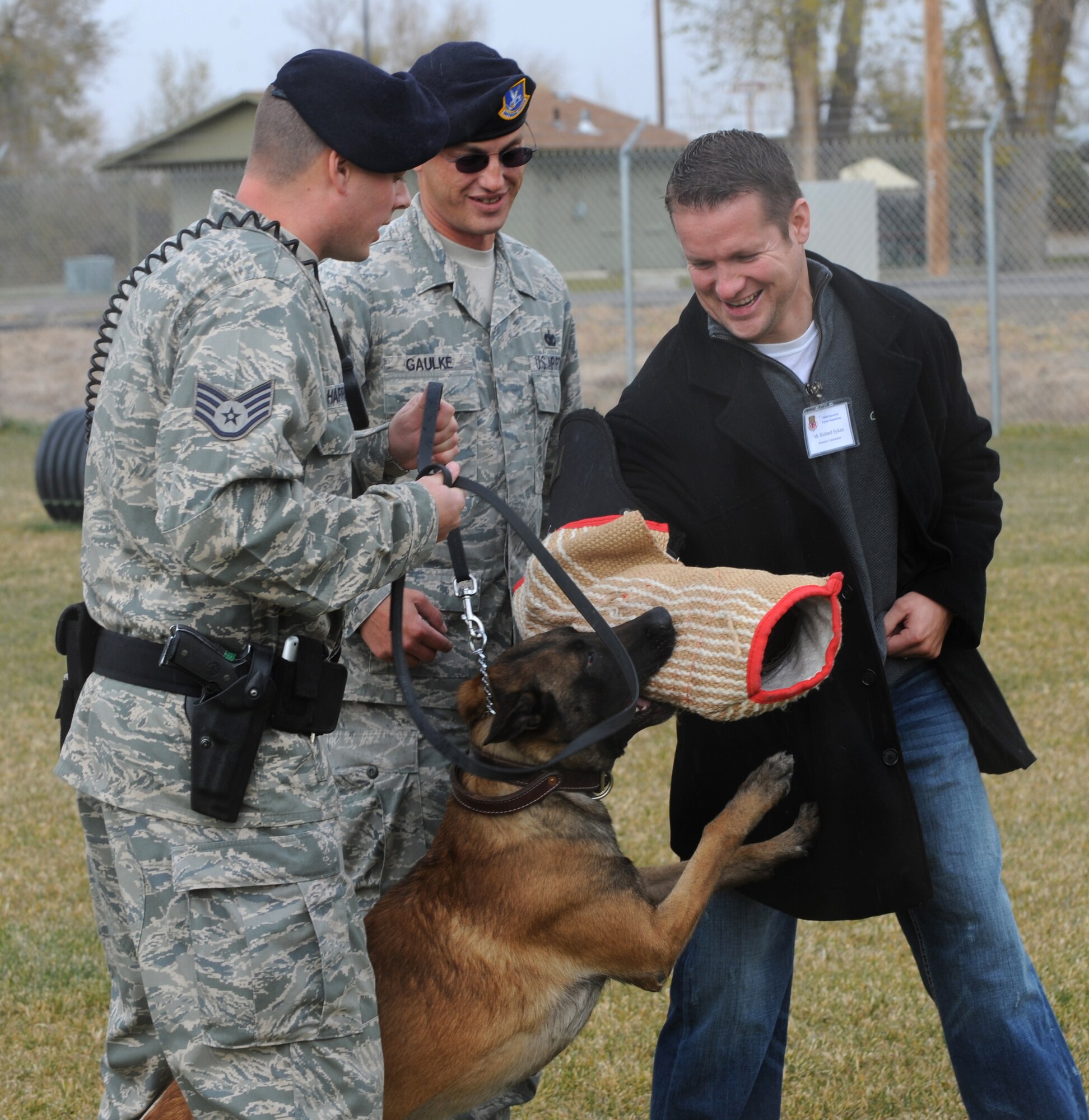 MOUNTAIN HOME AIR FORCE BASE, Idaho -- Rich Sykes, 366th Security Forces Squadron honorary commander, serves as an attack subject as Staff Sgt. Joshua Harrison and Tech. Sgt. William Gaulke, 366th SFS military working dog handlers, stand by the MWD training area as part of a demonstration for the Honorary Commander Mission Support Group Orientation Tour Nov. 6. The honorary commanders program is a wing-level program that pairs civic leaders with squadron, group and wing leaders to enhance the relationships between local communities and the base. It also provides a rare glimpse of life on a military installation to members of neighboring communities -- many of whom have no connection to the Air Force or prior knowledge of the military. (U.S. Air Force photo by Airman 1st Class Debbie Lockhart)