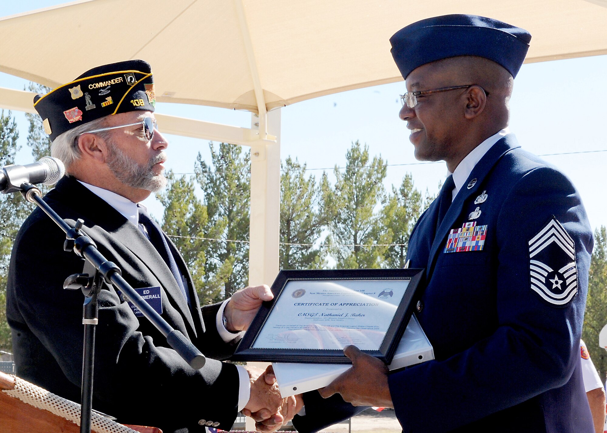 TULAROSA, N.M. -- Ed Summerall, president of the American Legion of 108, presents Chief Master Sgt. Jerome Baker, 49th Mission Support Group superintendent, with a certificate of appreciation on Veteran's Day, Nov. 11, at Veteran's Park in Tularosa. Chief Baker was the guest speaker during the Veteran's Day celebration which honored military veterans. (U.S. Air Force photo by Staff Sgt. Anthony Nelson Jr.)
