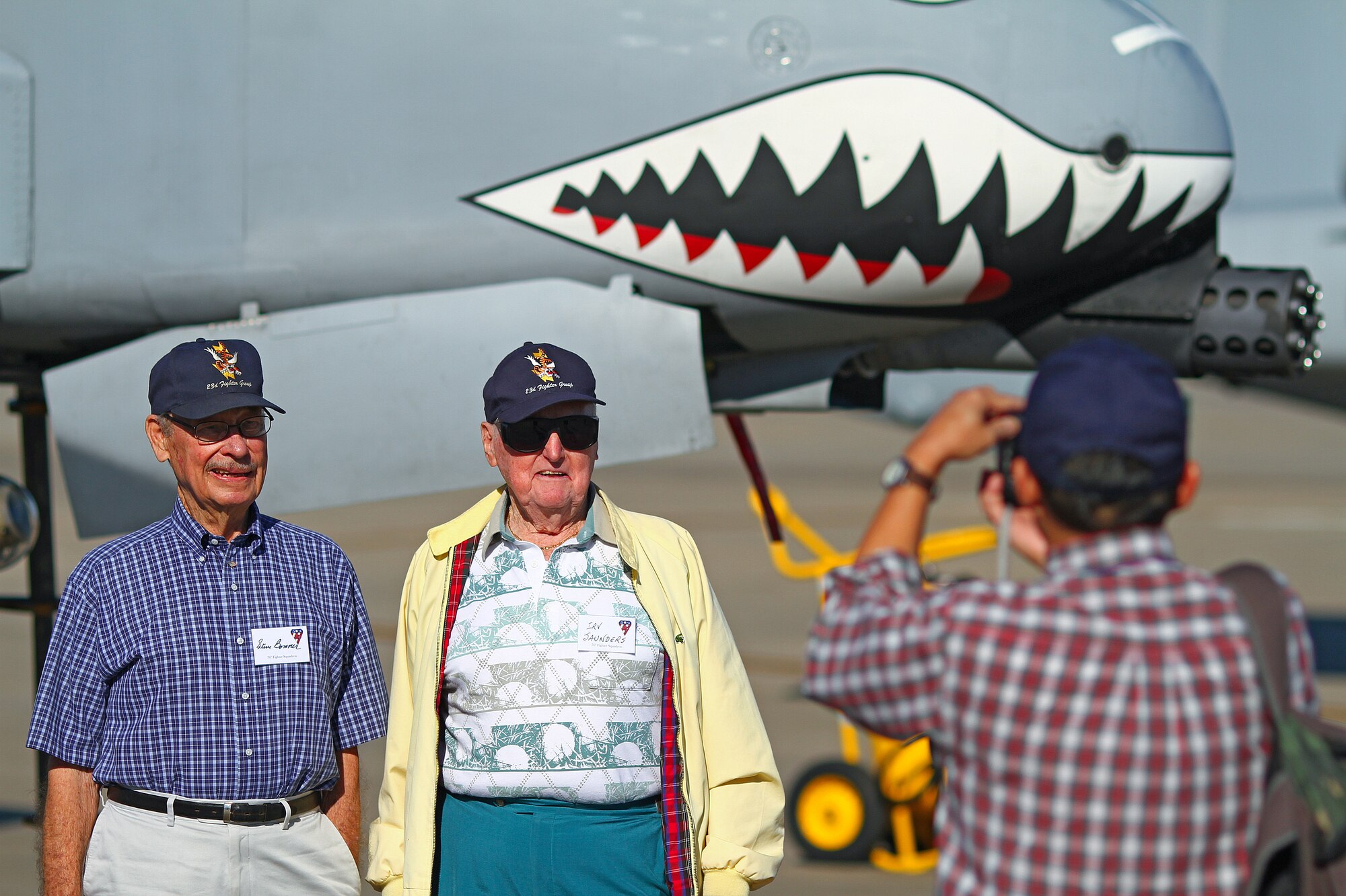 Two former members of the Flying Tigers pose in front of an A-10 Thunderbolt C on the Hurlburt Field runway Nov. 13. Three former pilots and crew chiefs of the 23rd Fighter Group, Moody Air Force Base, Ga., were honored with their names stenciled on the side of the plane. "I've read all the history books regarding this group, but these guys are the real heroes," said Col. Skip Hinman, 23rd Fighter Group commander. "Though just a few names are recognized today, they really symbolize all of the Flying Tigers and the planes we've flown." 