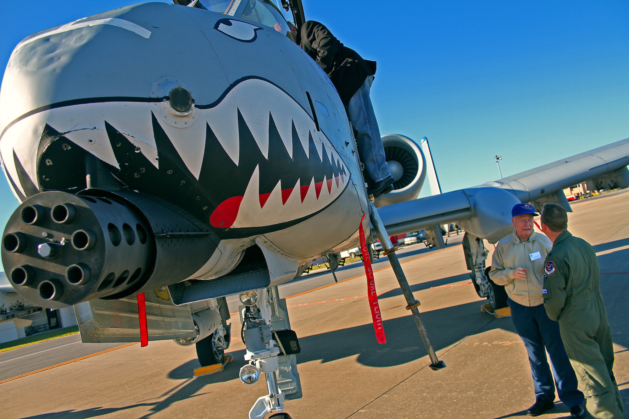Members of the Flying Tigers reunion explore an A-10 Thunderbolt C on the Hurlburt Field runway. Three former pilots and crew chiefs of the 23rd Fighter Group, Moody Air Force Base, Ga., were honored with their names stenciled on the side of the plane. "I've read all the history books regarding this group, but these guys are the real heroes," said Col. Skip Hinman, 23rd Fighter Group commander. "Though just a few names are recognized today, they really symbolize all of the Flying Tigers and the planes we've flown." 