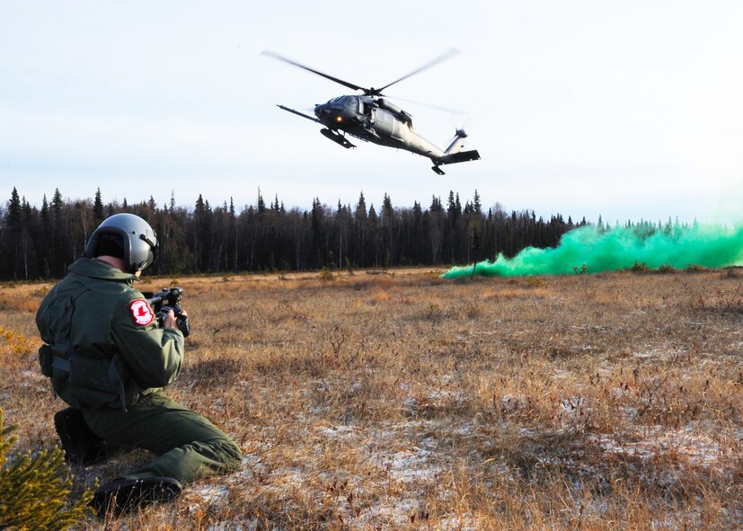 Staff Sgt. Mark Leahy takes video footage of a HH-60G Pave Hawk performing training missions near Elmendorf Air Force Base, Alaska, Nov. 4, 2009. The Kulis Air National Guard Base rescue squadrons conduct training sorties five days a week around the Alaska airspace. Sergeant Leahy is a videographer with the 3rd Wing Public Affairs office. (U.S. Air Force photo/Senior Airman Cynthia Spalding)