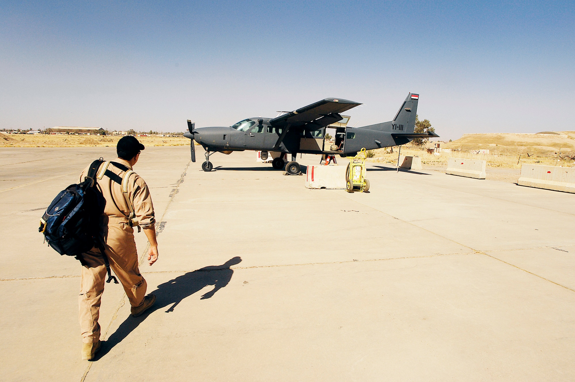 An Iraqi pilot walks to a Iraqi AC-208 Caravan for a training mission at Kirkuk Regional Air Base, Iraq. For the first time since the re-formation of the Iraqi air force, an Iraqi pilot fired a missile from an a AC-208 Nov. 04, 2009, at a target on a bombing range near Al Asad Air Base, Iraq.  (U.S. Air Force photo/Staff Sgt. Aaron Allmon)