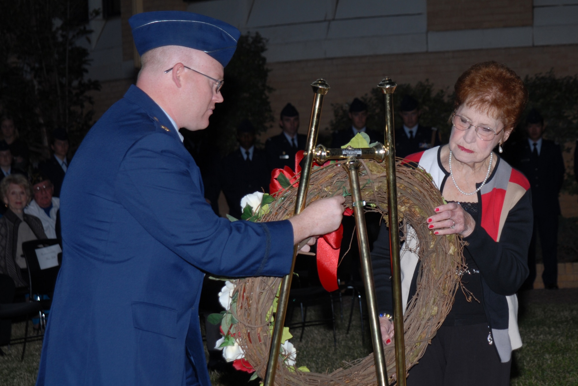 SAN ANGELO, Texas -- Maj. Cody Whittington and Ava Davis place a wreath at Memorial Oak Grove during the Veterans Day vigil at Angelo State University, Nov. 11, 2009. Ms. Davis is the sister of Army Air Corps Cpl. Frank Tubbs who was a radio operator with the 345th Bombardment Group who was killed-in-action during World War II. Maj. Whittington is Commandant of Cadets at ASU. (U.S. Air Force photo/Staff Sgt. Laura R. McFarlane)
