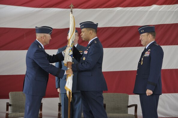 Maj. Gen. Garry Dean, center, accepts the organizational flag from Gen. Gene Renuart, left, commander of NORAD and U.S. Northern Command, as the outgoing commander, Maj. Gen. Hank Morrow, far right, looks on during the Continental U.S. NORAD Region-1st Air Force (Air Forces Northern) change of command ceremony Nov. 12 at Tyndall AFB, Fla. (Photo by Jonathan Gibson) 
