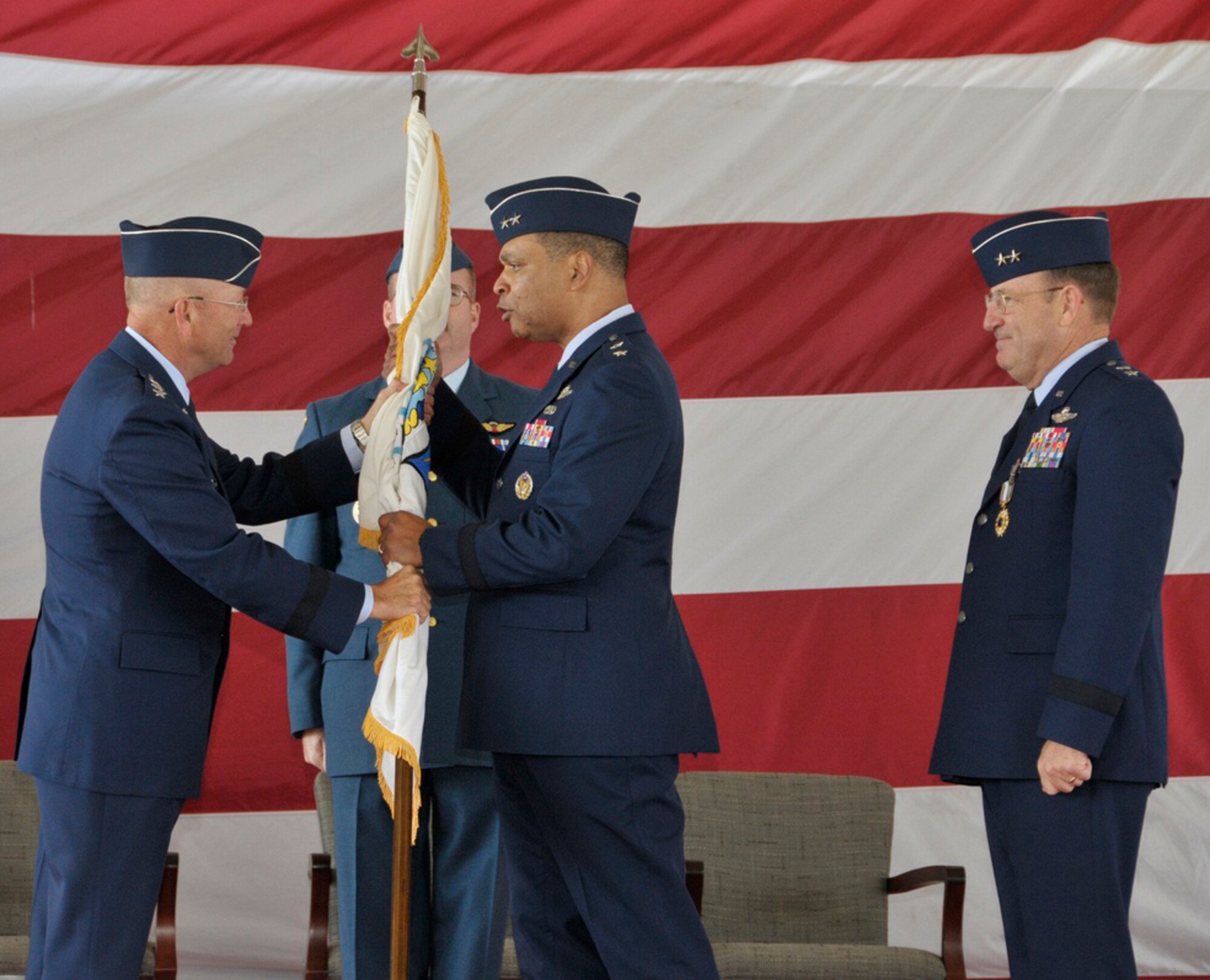 Maj. Gen. Garry Dean, center, accepts the organizational flag from
Gen. Gene Renuart, left, commander of NORAD and U.S. Northern Command, as
the outgoing commander, Maj. Gen. Hank Morrow, far right, looks on during
the Continental U.S. NORAD Region-1st Air Force (Air Forces Northern) change
of command ceremony Nov. 12 at Tyndall AFB, Fla.(U.S. Air Force photo by Lisa Norman)
