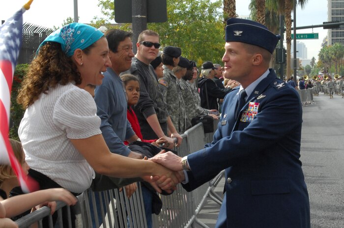 LAS VEGAS -- Col. Dave Belote, 99th Air Base Wing commander, greets a Las Vegas citizen during the 2009 Las Vegas Veteran's Day Parade Nov. 11.  Veteran's Day  recognizes and honors all who have served in the U. S. Armed Forces.  (U.S. Air Force photo/ Staff Sgt. Taylor Worley)