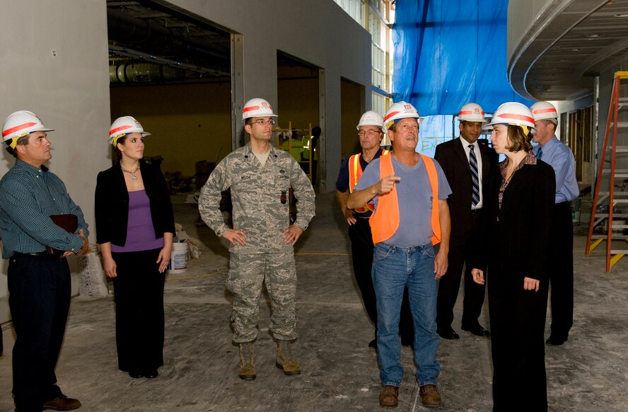 Dale Campbell, Army Corps of Engineers (right, wearing orange vest), tells Kara Stencel, Legislative Director for Congressman Allen Boyd, about the construction of Tyndall Air Force Base's new fitness center. Also touring are Pat Kelly, 325th Civil Engineer Squadron Programs Flight Chief, Cassie Muffley, 325th CES Project Programmer, Lt. Col. Keith Welch, 325th CES Commander, Lou South, Tyndall Fitness Center Director, Maj. Bill Bridgemohan, Military Fellow with Congressman Allen Boyd, and Brian Stahl, 325th CES deputy commander. (U.S. Air Force photo by Jonathan Gibson)