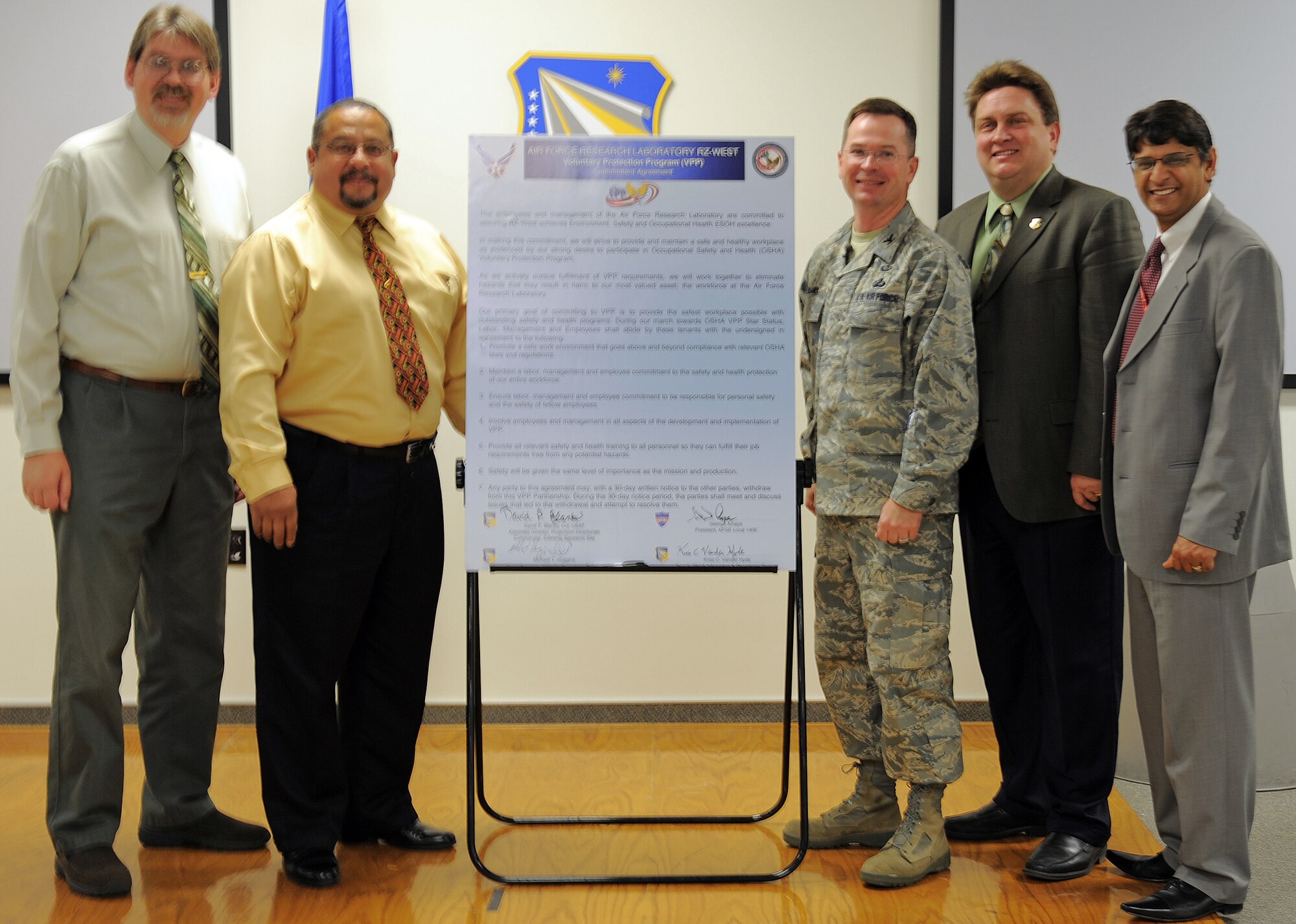 From left to right: Kris Vanderhyde, Air Force Research Laboratory Integration and Operations division, Mike Huggins, AFRL site director, George Amaya, American Federation of Government Employees Local 1406 president, Col. David Blanks, AFRL Detachment 7 commander and Dr. Ashwani Vij, Voluntary Protection Plan program lead, pose for a photo after signing a VPP commitment agreement Nov. 10. The VPP promotes work site safety and health. In the VPP, management, labor and Occupational Safety and Health Administration establish cooperative relationships at workplaces that have implemented a comprehensive safety and health management system. (Air Force photo/Ronald Fair)