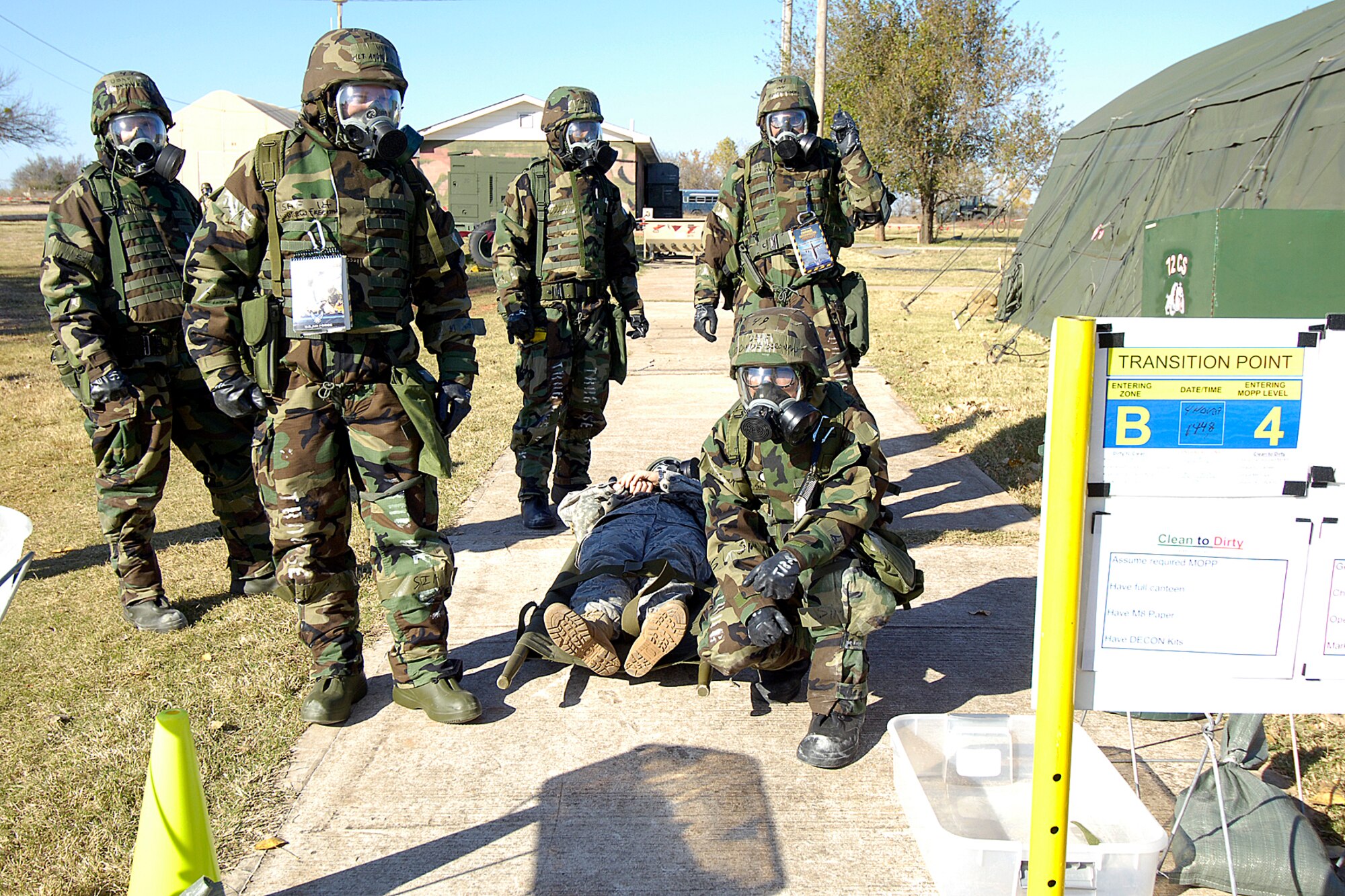 Airmen wait for permission to take a “wounded” Airman through a zone transition point at Glenwood Training Area during an ORI exercise last week. (Air Force photo by Margo Wright)