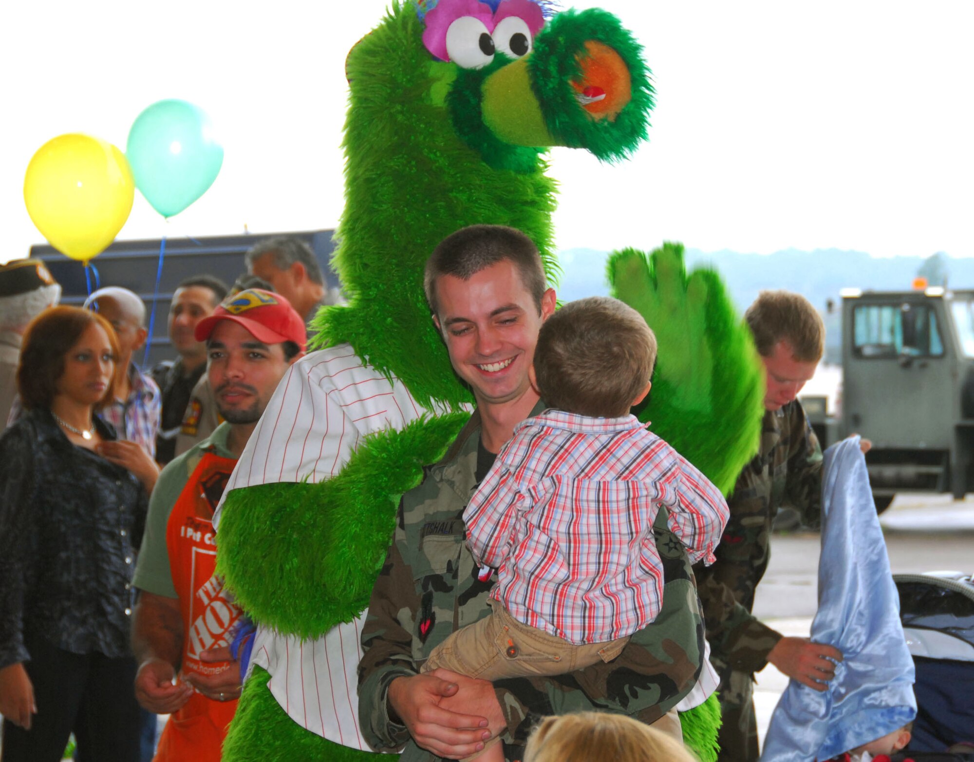 Senior Airman Peter Gottshalk II, 201st RED HORSE Squadron Detachment 1, and his son are greeted by the Philly Phanatic during Family Day Oct. 3 at Willow Grove Air Reserve Station, Pa.