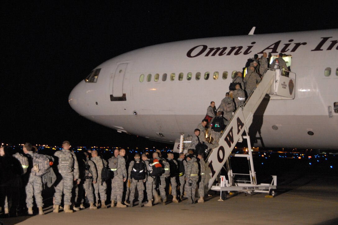 During the early evening hours of November 02, 2009, deploying members of the 132nd Fighter Wing, Des Moines, Iowa board a contract carrier located on the south ramp of the 132nd as part of their scheduled Aerospace Expeditionary Forces (AEF) rotation in support of Operation Iraqi Freedom. (U.S. Air Force photo/Senior Master Sgt. Tim L. Day)(released)