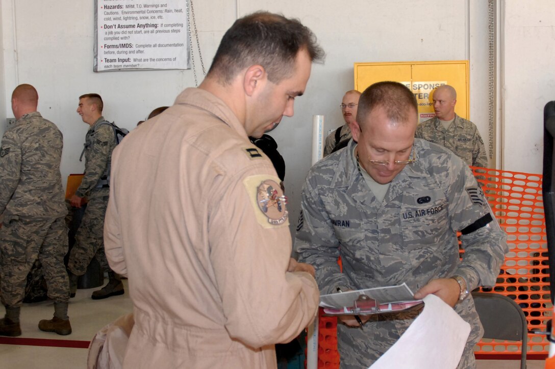 Tech. Sgt. Paul Havran checks an Airman's identification tags and common access card (CAC) against a deployment passenger manifest in the deployment line set up in the main hangar of the 132nd Fighter Wing, Des Moines, Iowa on November 2, 2009. Sgt. Havran?s check point is the first stop for Airman deploying as part of the 132nd Fighter Wing's scheduled Aerospace Expeditionary Forces (AEF) rotation in support of Operation Iraqi Freedom. (U.S. Air Force photo/Senior Master Sgt. Tim L. Day)(released)