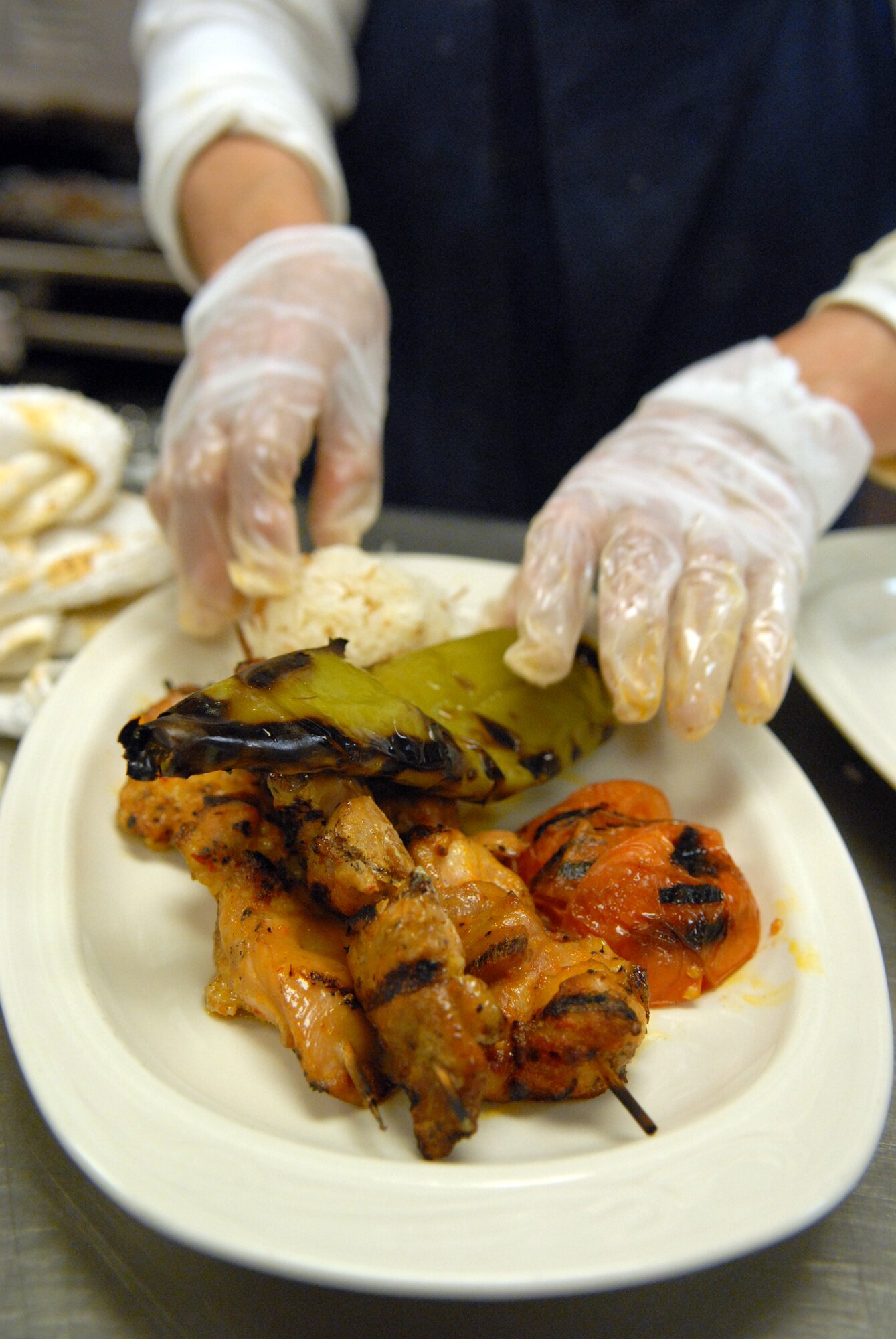 VANDENBERG AIR FORCE BASE, Calif. -- Making each dish, fresh and on the spot, Sakine Luzero and her team arrange traditional Turkish food for the Pacific Coast Club's first Passport to Turkey held here, Friday, Nov. 6, 2009. The menu included hummus, baba ghanoush, chicken and beef kabab, baklava and much more all made by hand during three extensive days of preparation.(U.S. Air Force photo/ Airman 1st Class Angelina Drake)